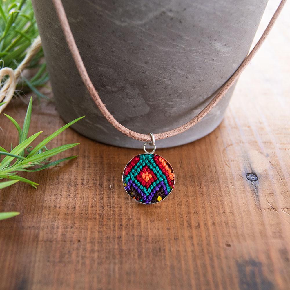 Mini Circle Friendship Necklace featuring a colorful textile pendant and leather string, handcrafted using traditional Chamula weaving techniques.