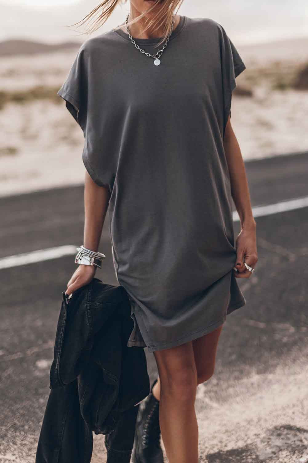 Gray mini dress with loose sleeves and round neckline, showcasing a relaxed fit and mid-thigh length.