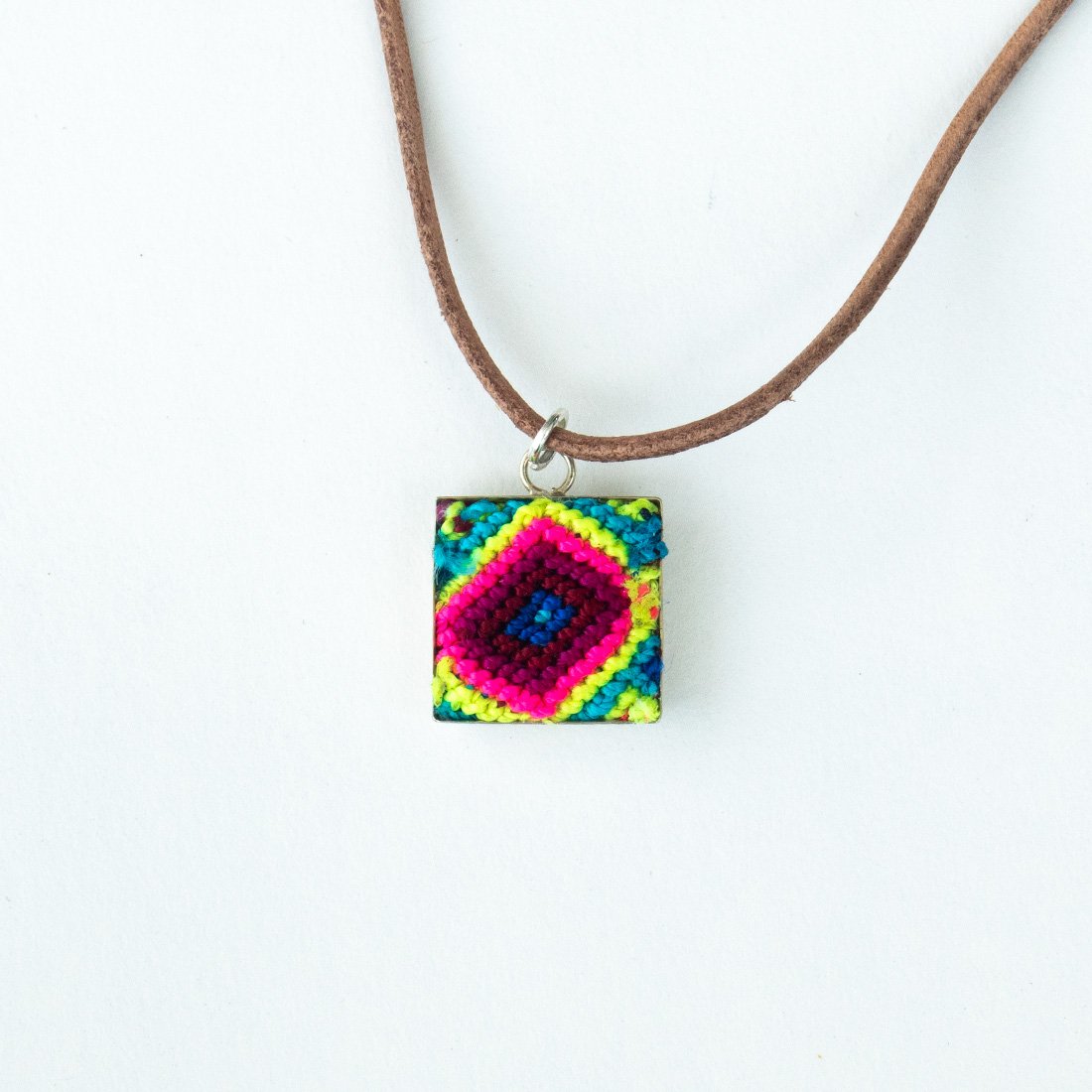 Mini Square Textile Necklace featuring a colorful woven pendant on a leather string, showcasing unique Chamula weaving from Mexico.