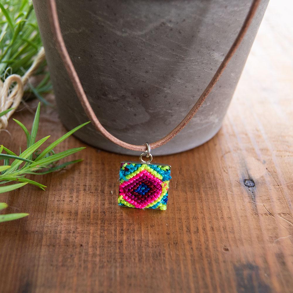 Mini Square Textile Necklace featuring a colorful woven pendant on a leather string, showcasing unique Chamula weaving from Mexico.