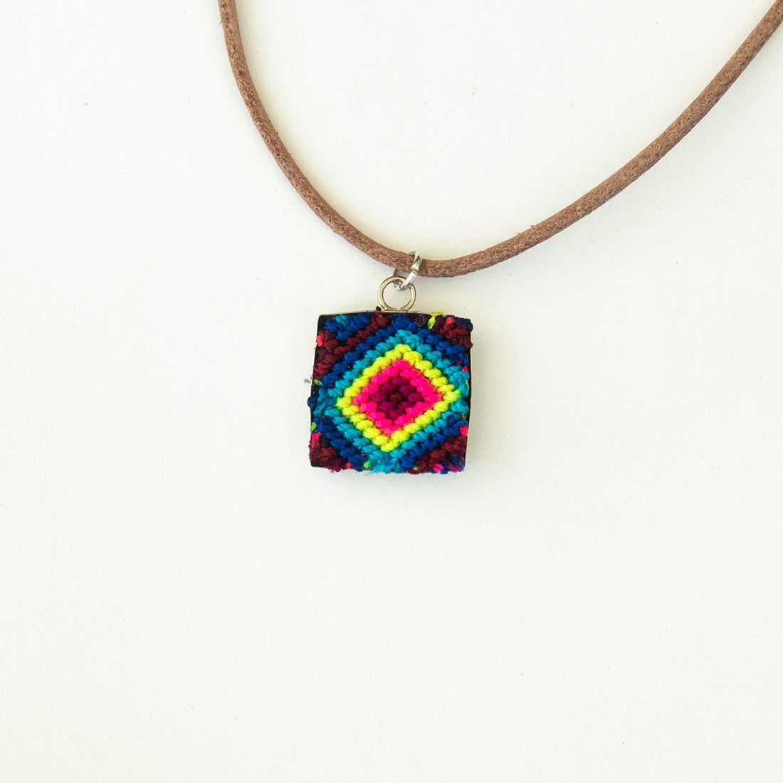 Mini Square Textile Necklace featuring a colorful woven pendant on a leather string, showcasing unique Chamula weaving from Mexico.