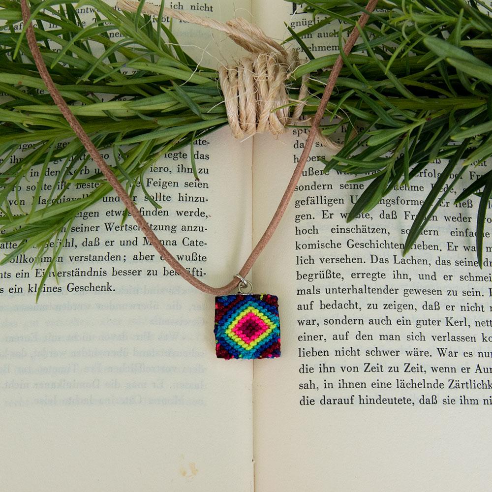 Mini Square Textile Necklace featuring a colorful woven pendant on a leather string, showcasing unique Chamula weaving from Mexico.