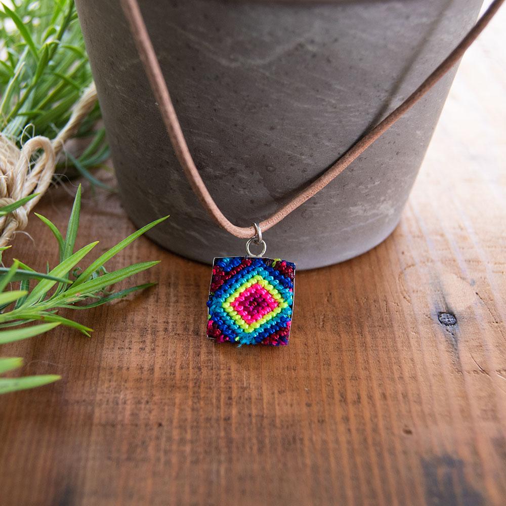 Mini Square Textile Necklace featuring a colorful woven pendant on a leather string, showcasing unique Chamula weaving from Mexico.