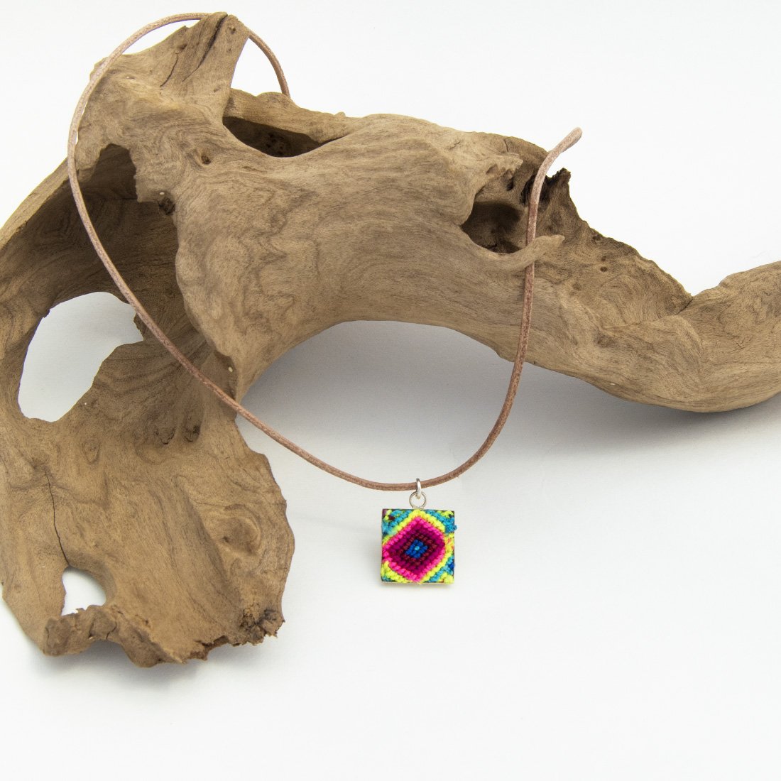 Mini Square Textile Necklace featuring a colorful woven pendant on a leather string, showcasing unique Chamula weaving from Mexico.