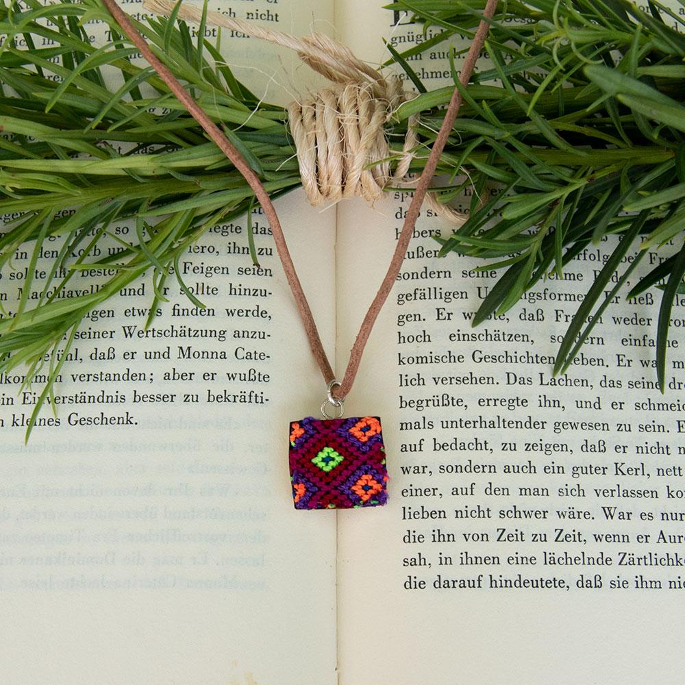 Mini Square Textile Necklace featuring a colorful woven pendant on a leather string, showcasing unique Chamula weaving from Mexico.