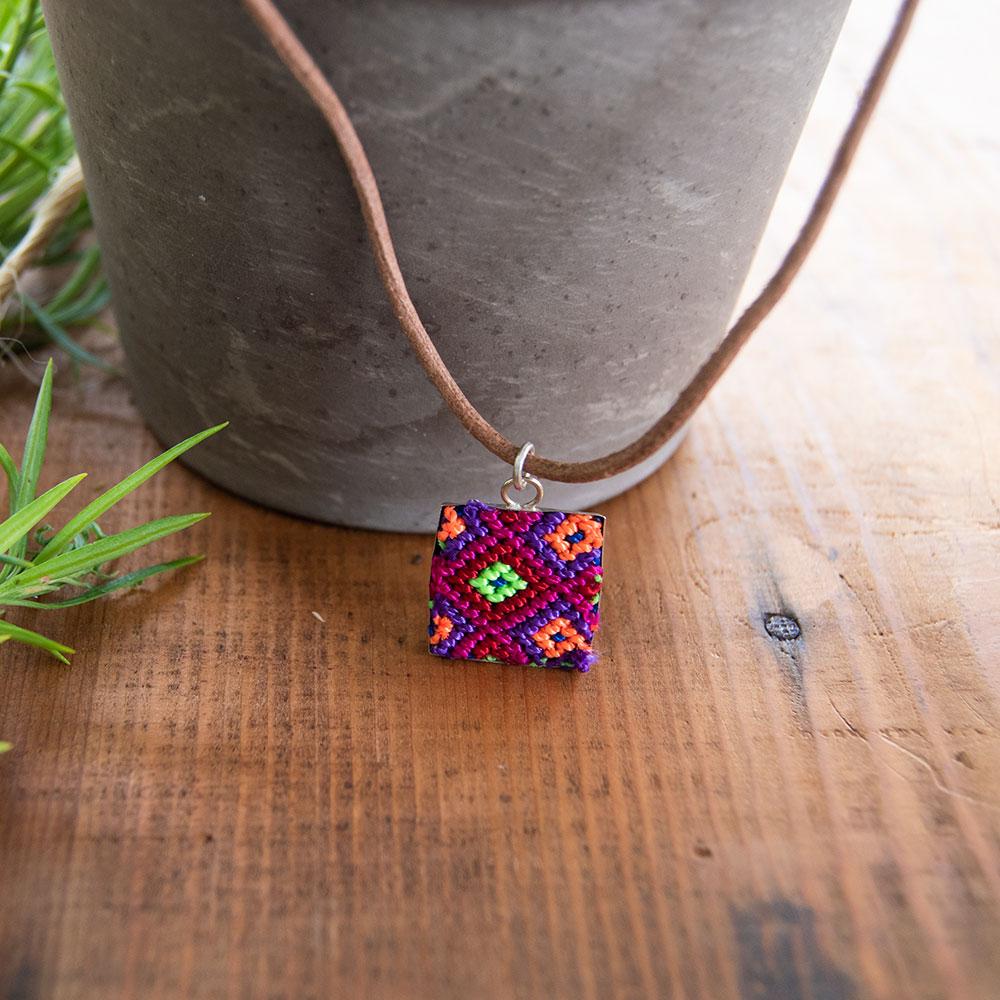 Mini Square Textile Necklace featuring a colorful woven pendant on a leather string, showcasing unique Chamula weaving from Mexico.