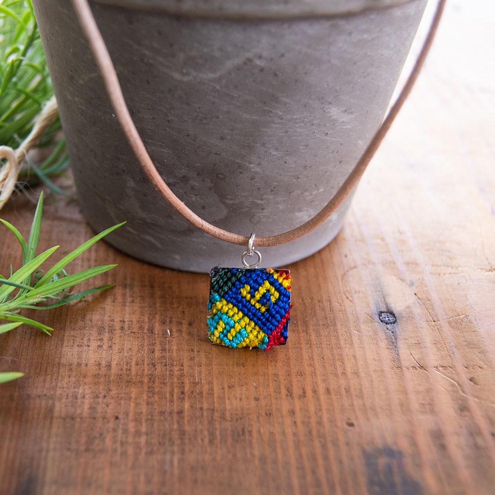 Mini Square Textile Necklace featuring a colorful woven pendant on a leather string, showcasing unique Chamula weaving from Mexico.