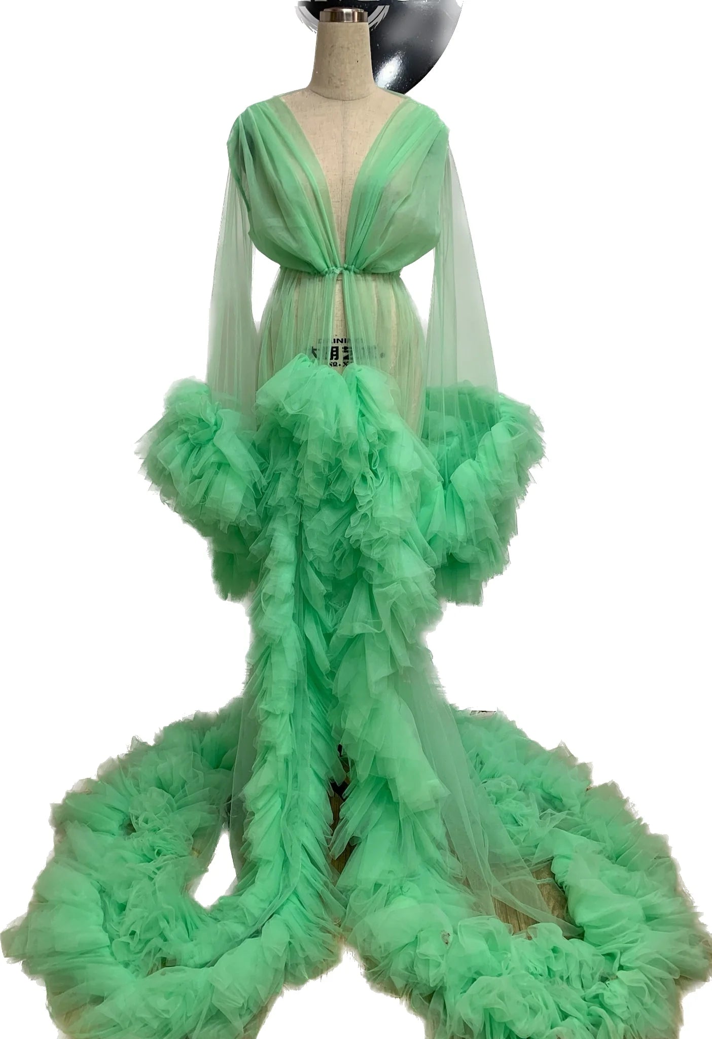 A beautiful mint ruffle robe made of soft tulle, showcasing its elegant design and flowing fabric, perfect for photoshoots.