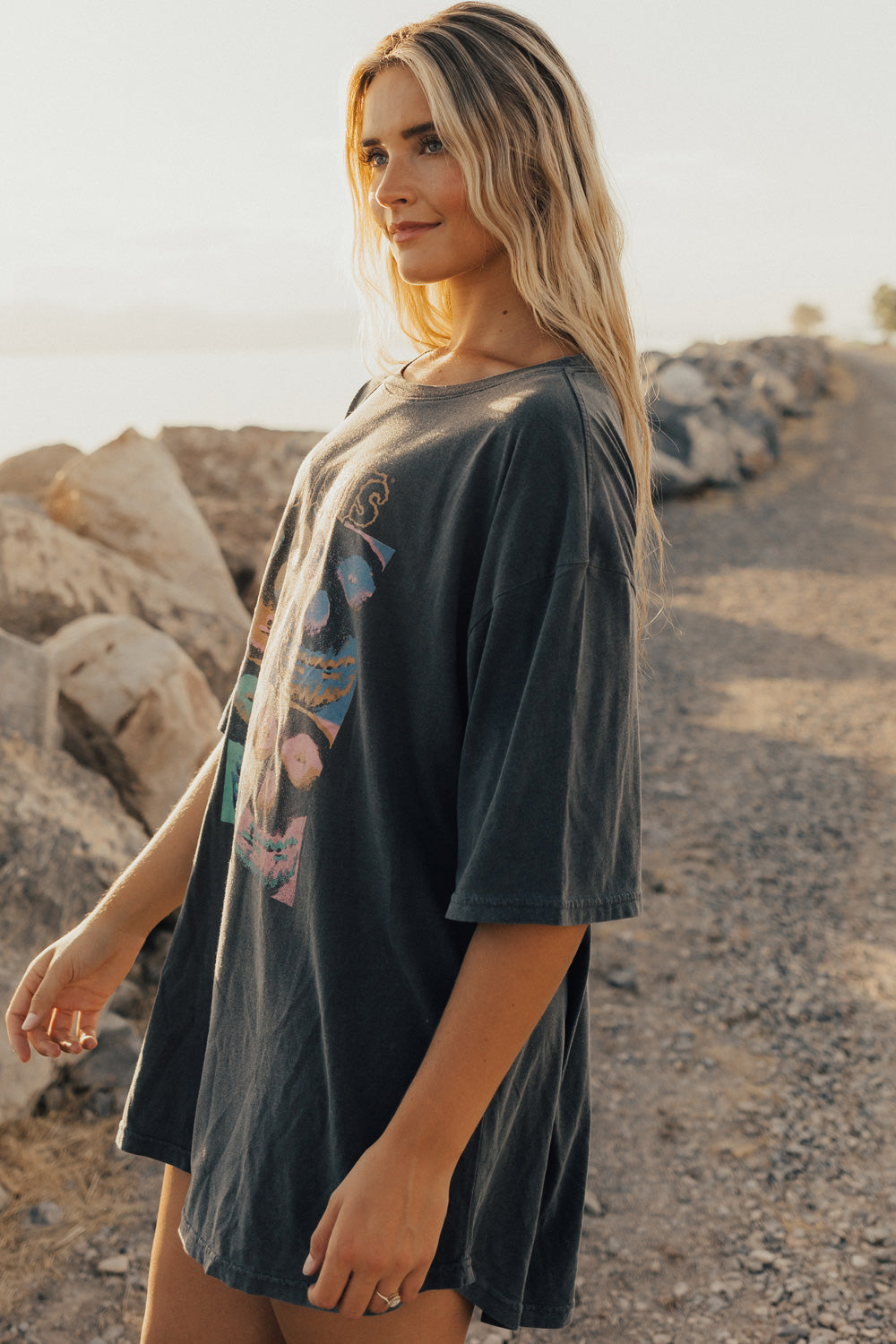 A stylish Misfits Oversized Repeat Tee in vintage black, showcasing its relaxed fit and eco-friendly fabric blend.