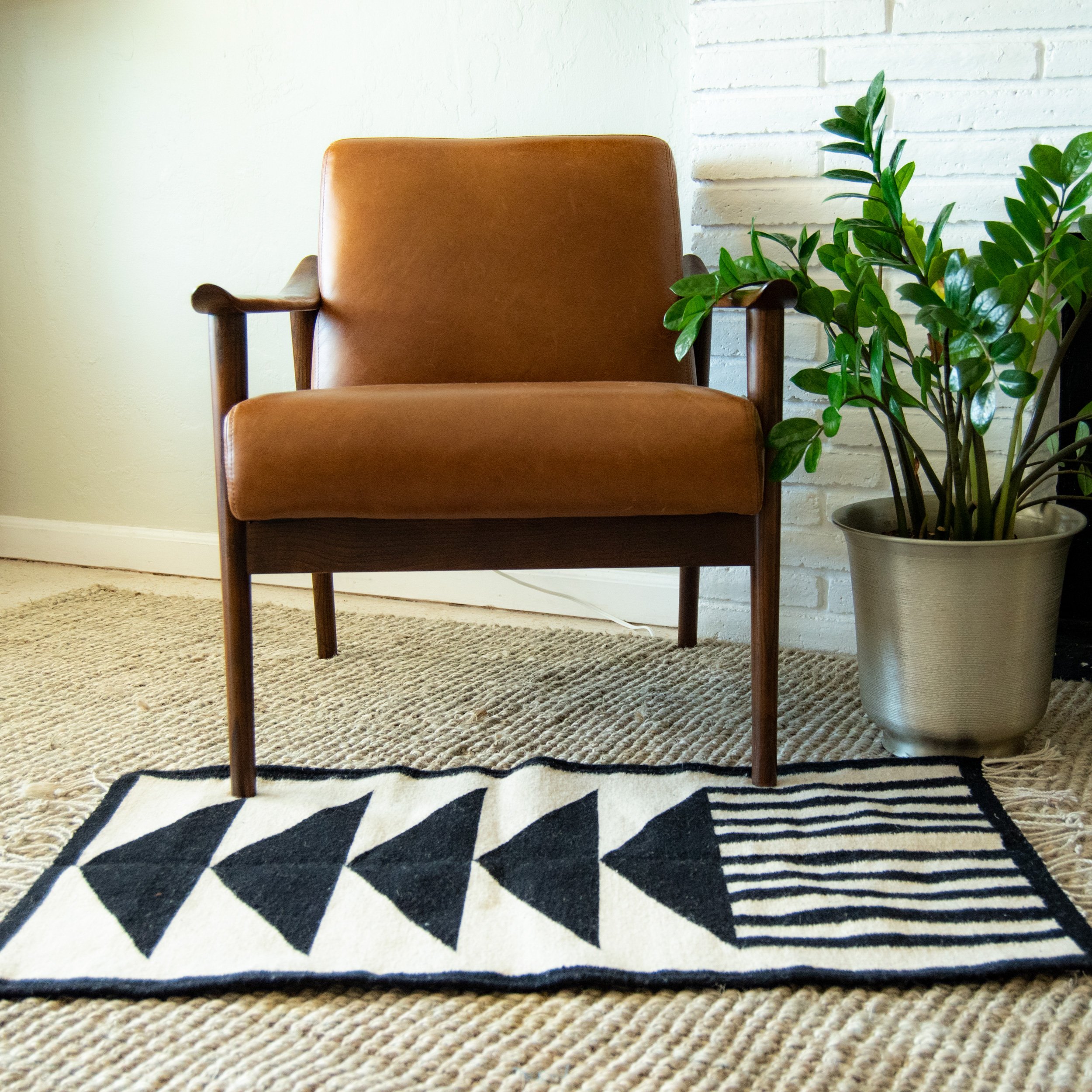 Mitla Asymmetric Black and White Wool Rug featuring geometric patterns, handmade on a waist loom, showcasing traditional craftsmanship.