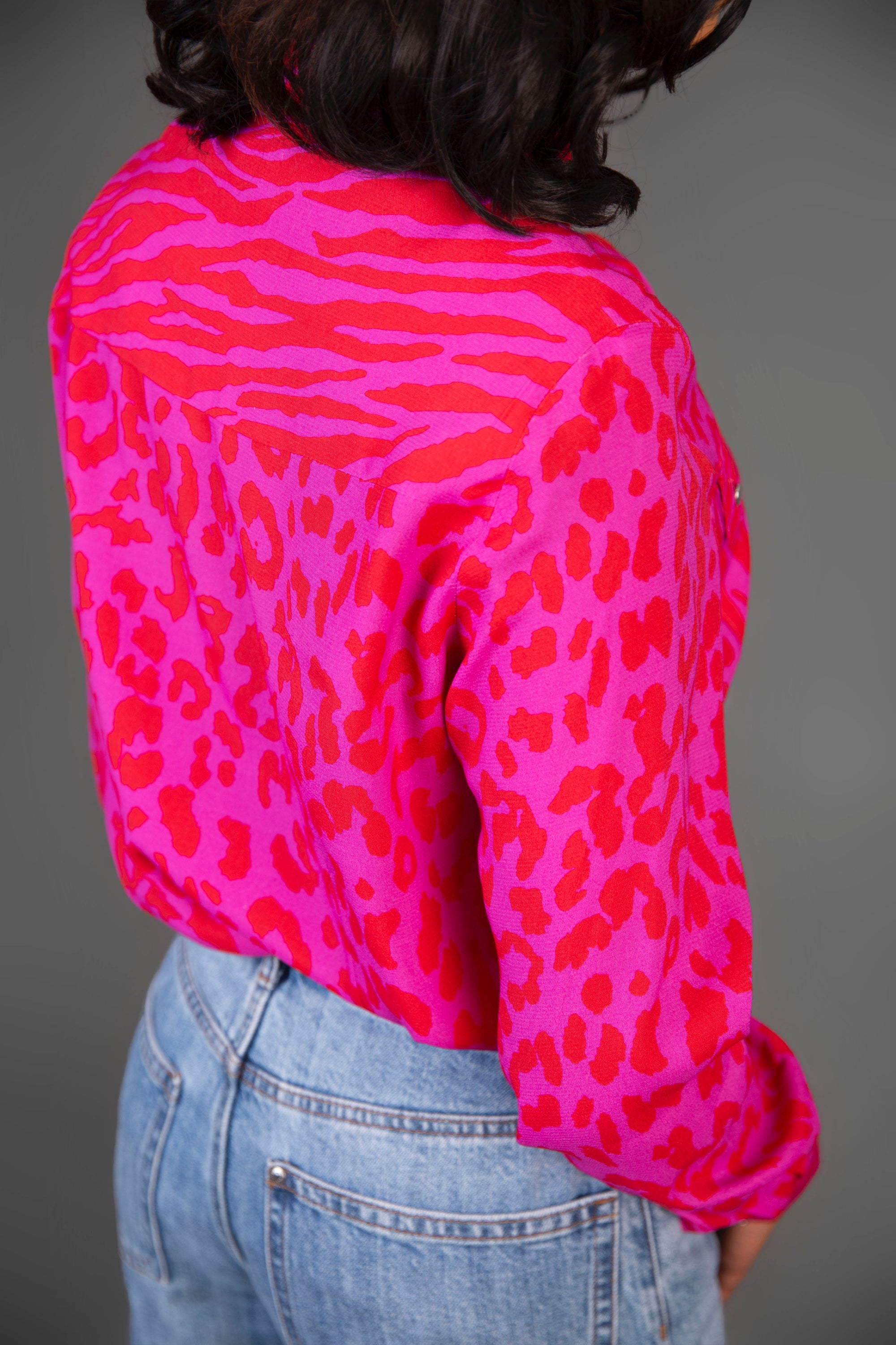 Stylish pink blouse featuring leopard and tiger prints with a tie front design, perfect for casual chic outfits.