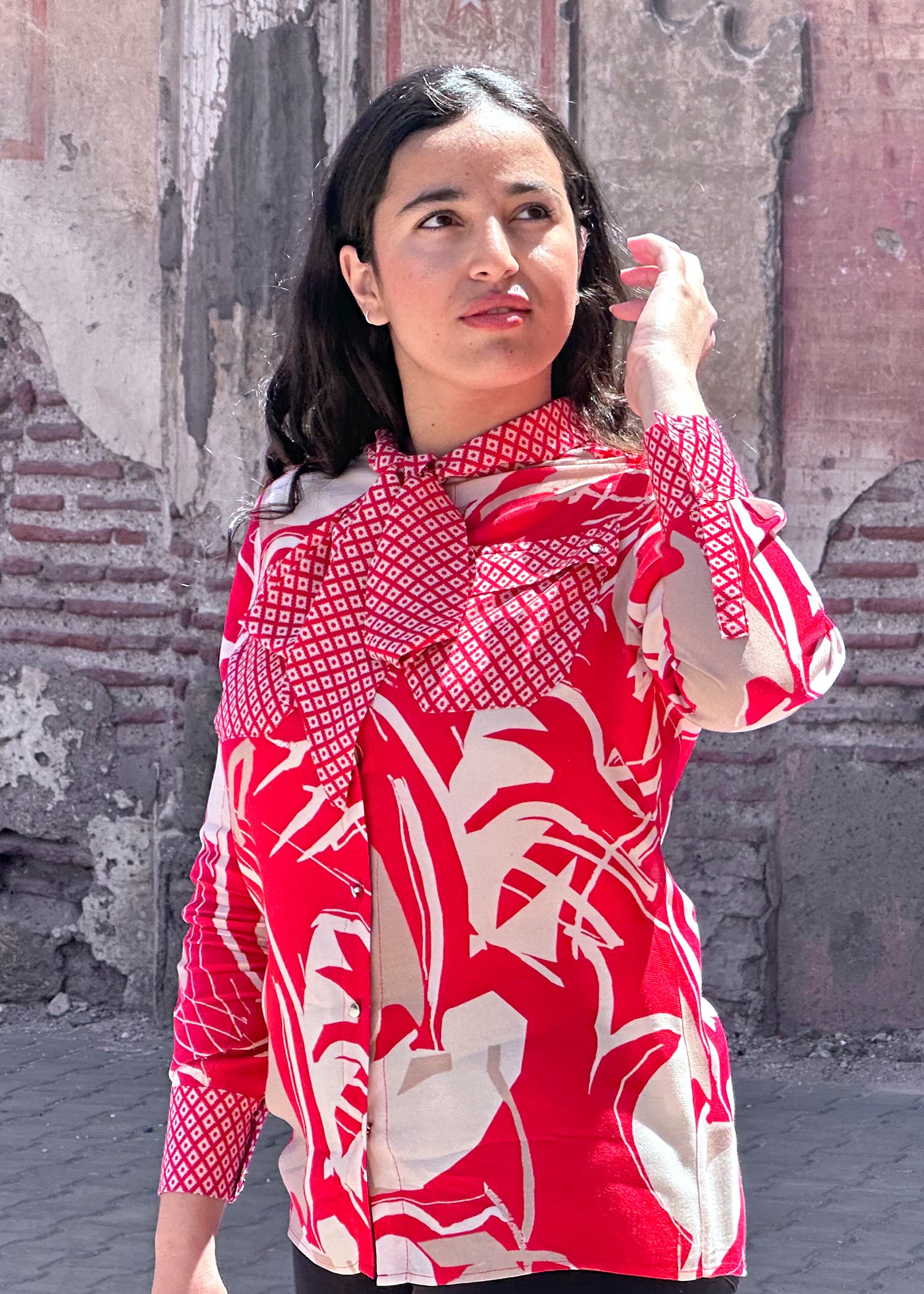 A vibrant red mixed print blouse featuring a stylish tie front design, perfect for casual and smart occasions.