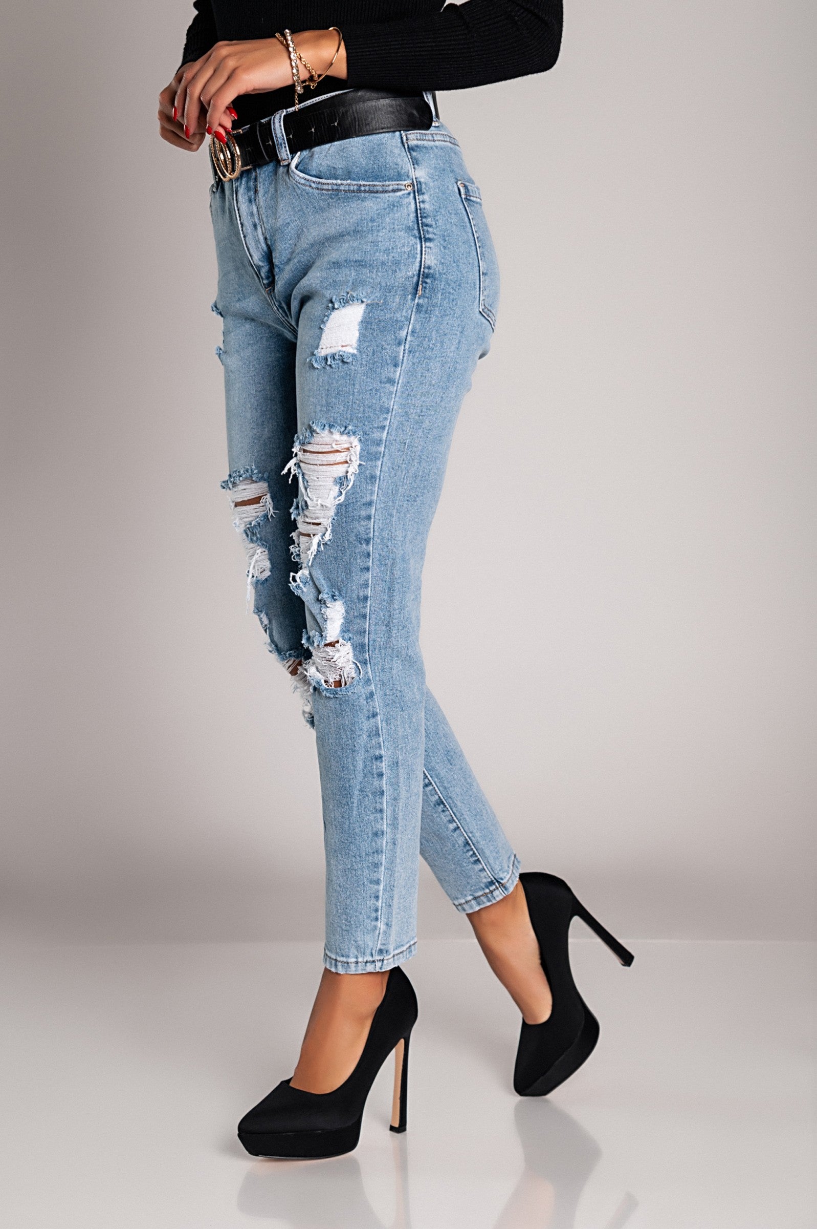 Light blue Mom fit jeans with rips, featuring a straight cut, front and back pockets, and a button and zipper closure.