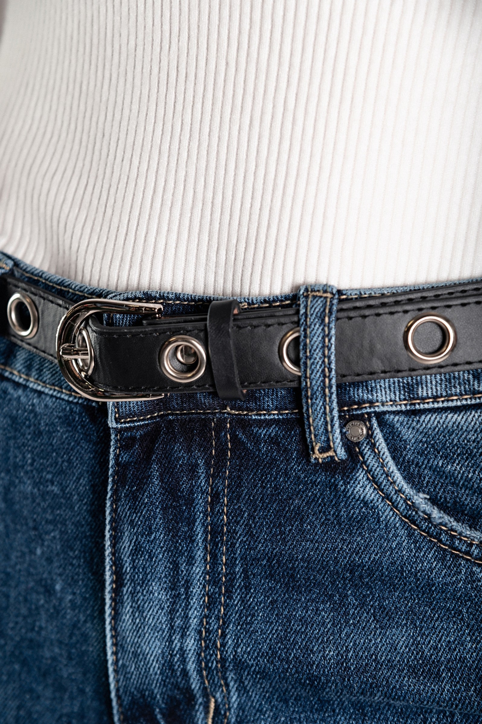 Close-up of black belt on jeans.