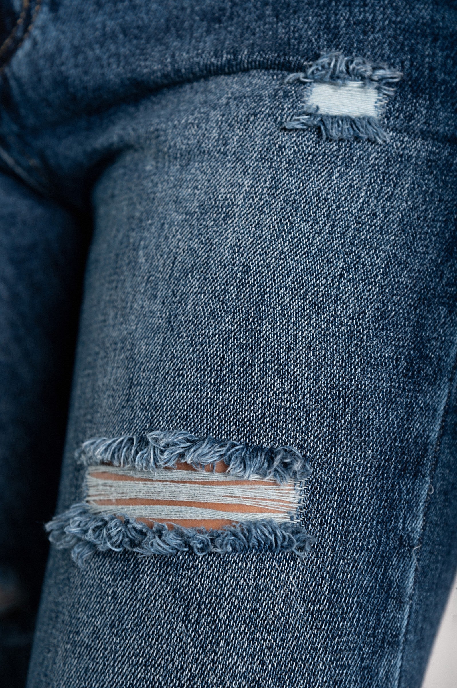 Close-up of ripped jeans.