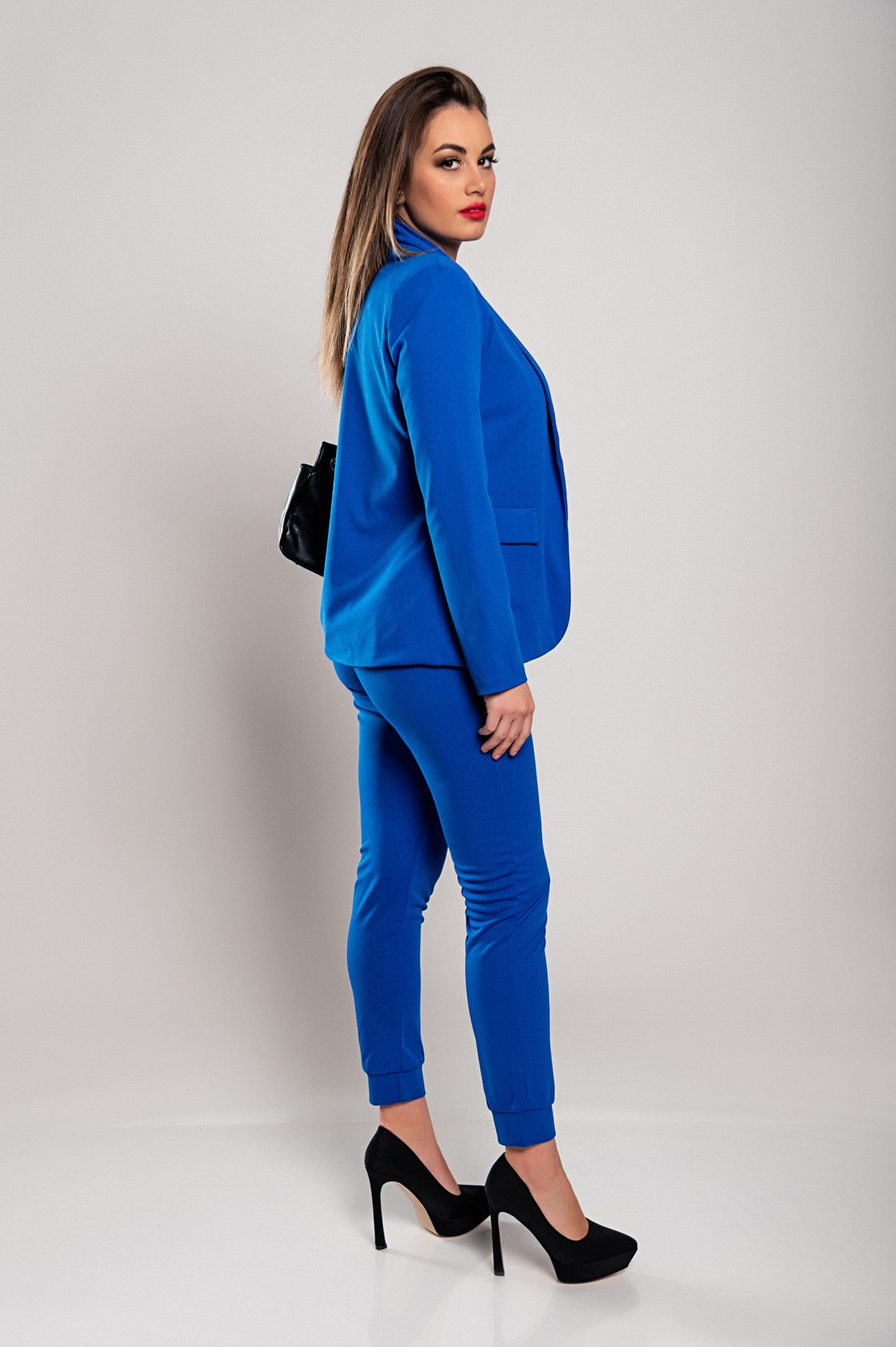 Monochrome elegant trousers and blazer set Estrena in blue, featuring a classic collar, long sleeves, and slim fit trousers with a drawstring waist.