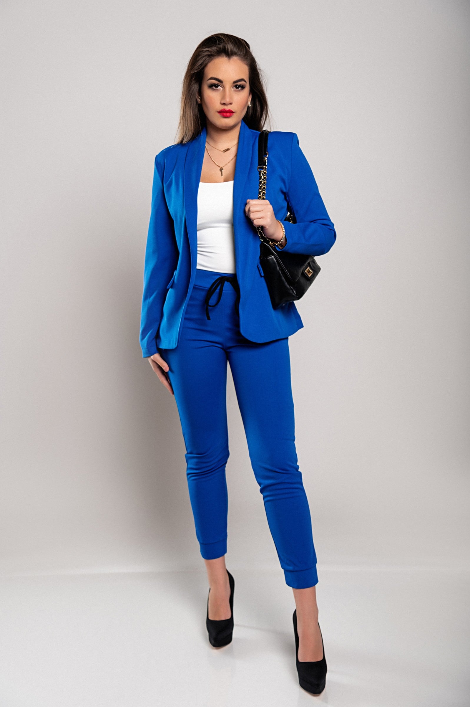 Monochrome elegant trousers and blazer set Estrena in blue, featuring a classic collar, long sleeves, and slim fit trousers with a drawstring waist.