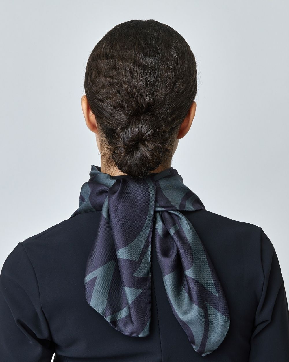 Elegant black silk scarf featuring Yagya's signature monogram print, measuring 30.7 inches, made in Italy.