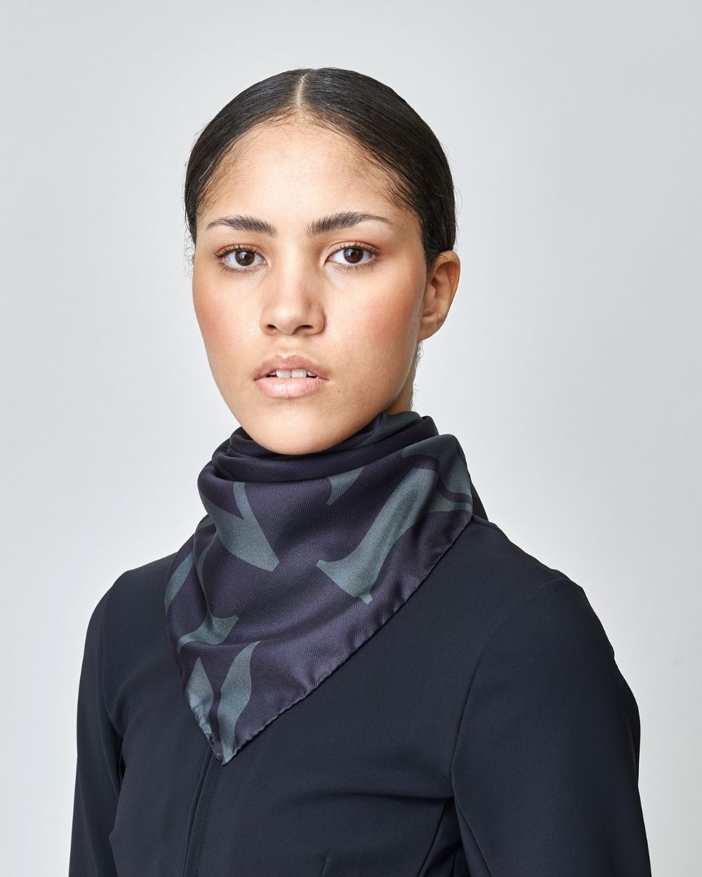 Elegant black silk scarf featuring Yagya's signature monogram print, measuring 30.7 inches, made in Italy.