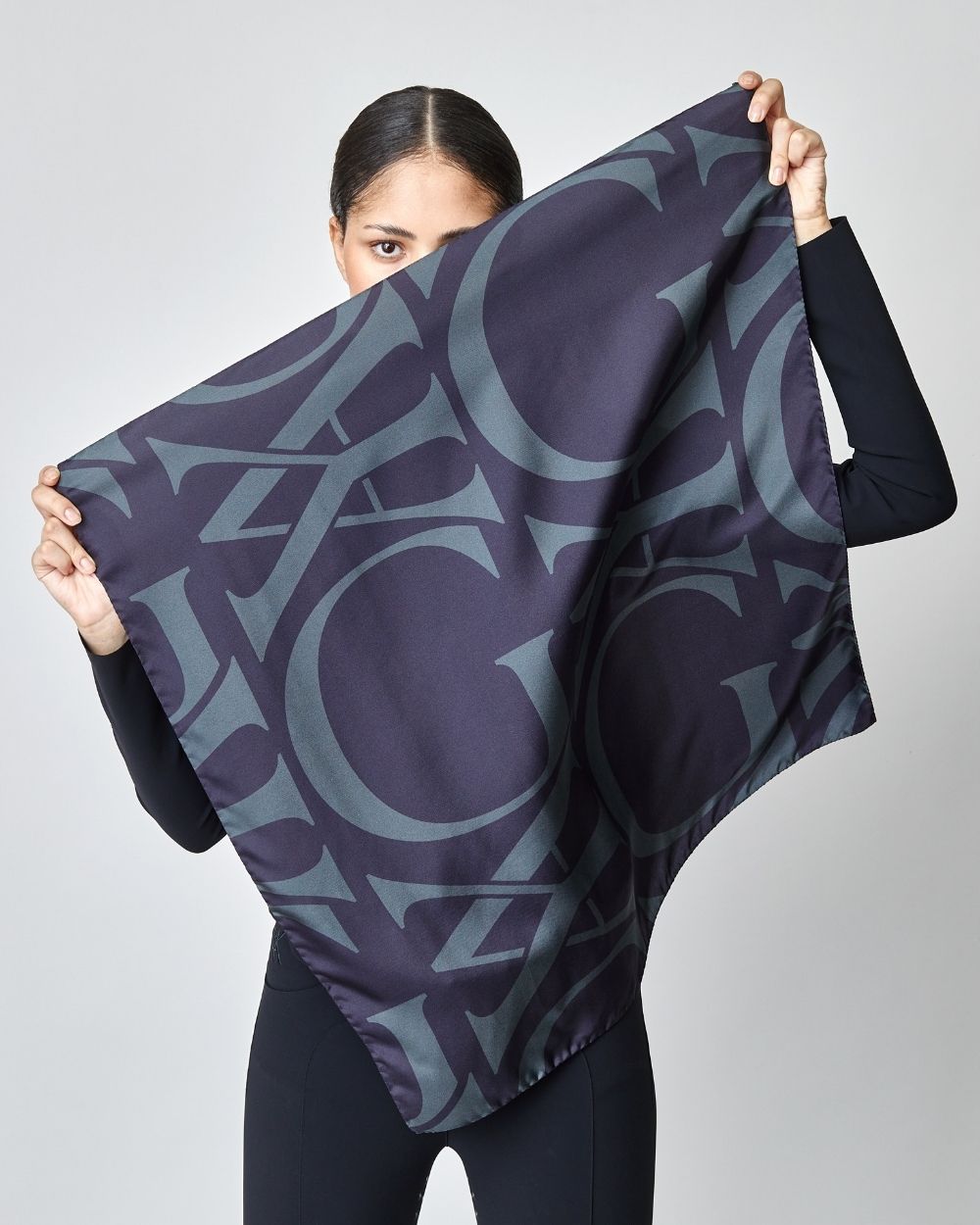 Elegant black silk scarf featuring Yagya's signature monogram print, measuring 30.7 inches, made in Italy.