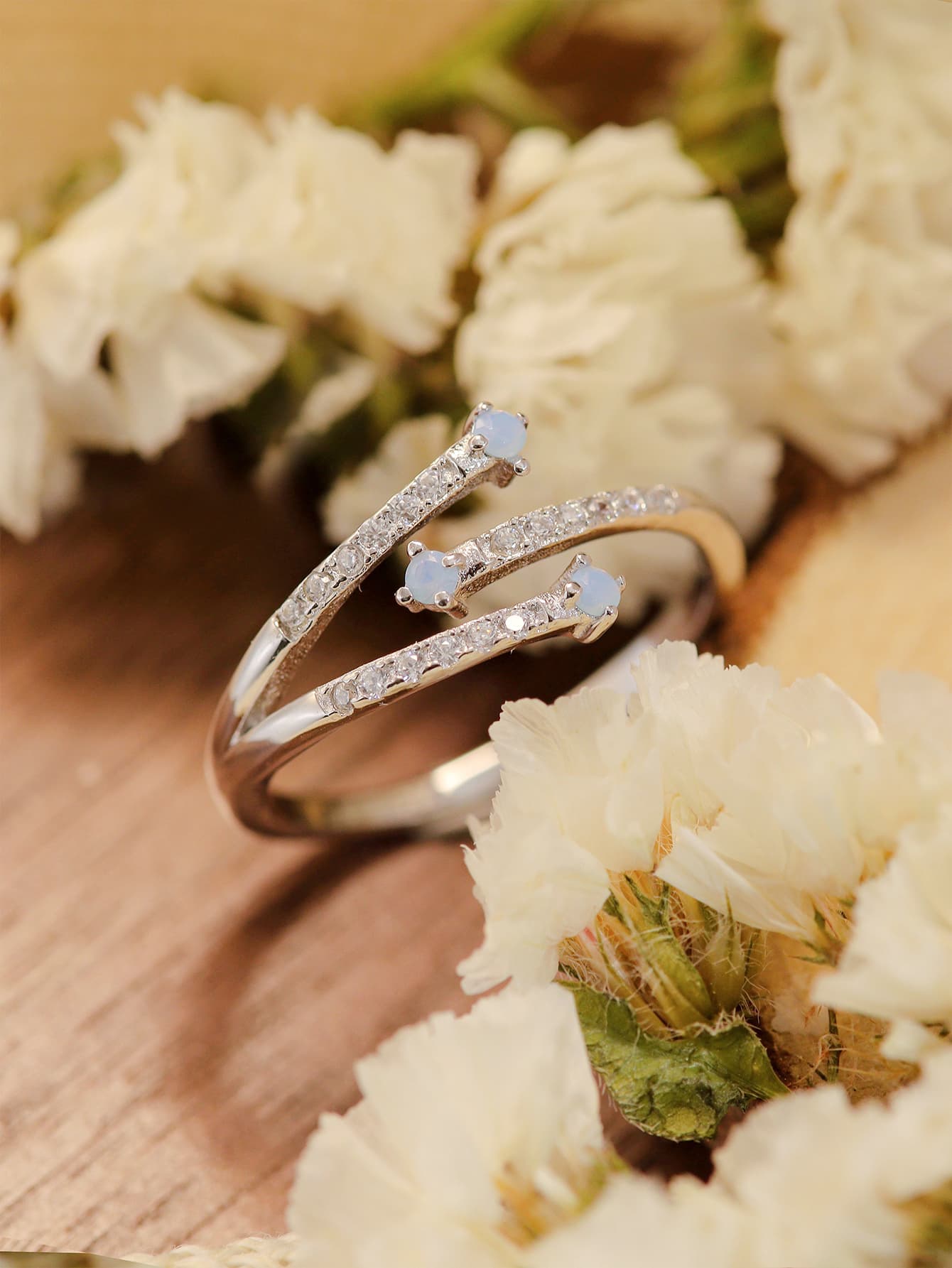 Moonstone Platinum-Plated Ring featuring a natural moonstone with blue-violet hues, set in 925 sterling silver and platinum plating.