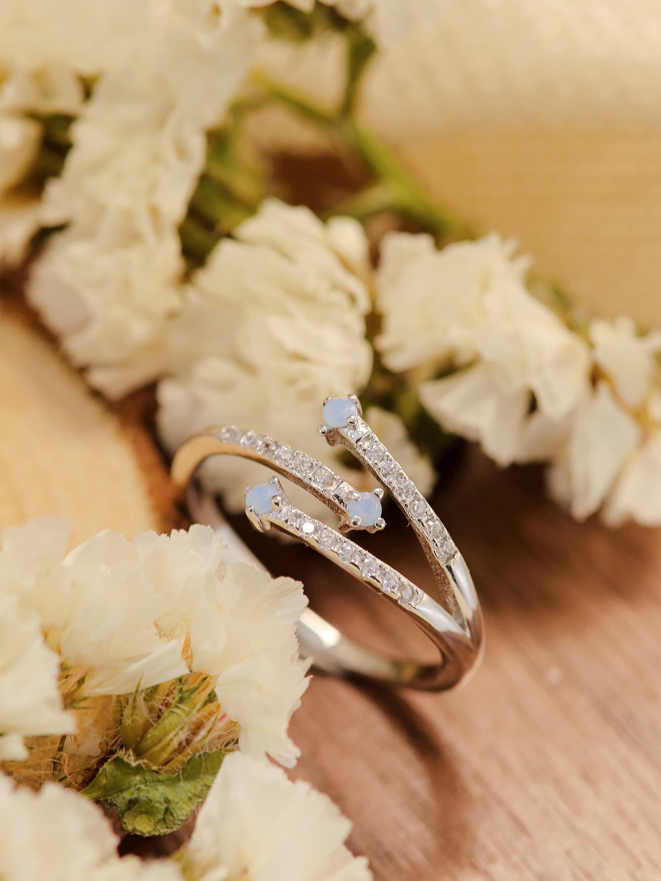 Moonstone Platinum-Plated Ring featuring a natural moonstone with blue-violet hues, set in 925 sterling silver and platinum plating.