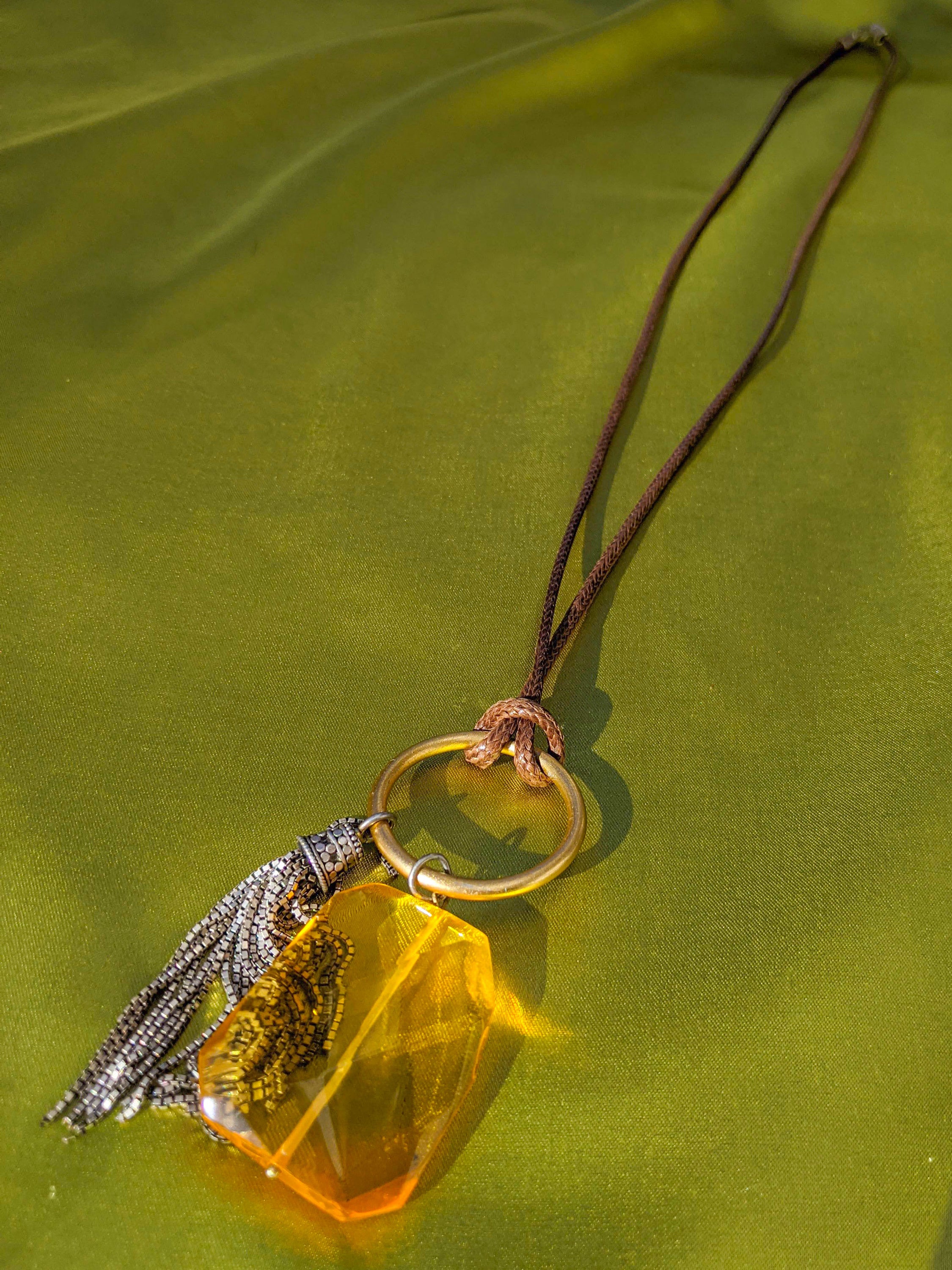 MORAY semi-precious crystal gem elegantly displayed on a silver chain, showcasing its unique design and sparkle.