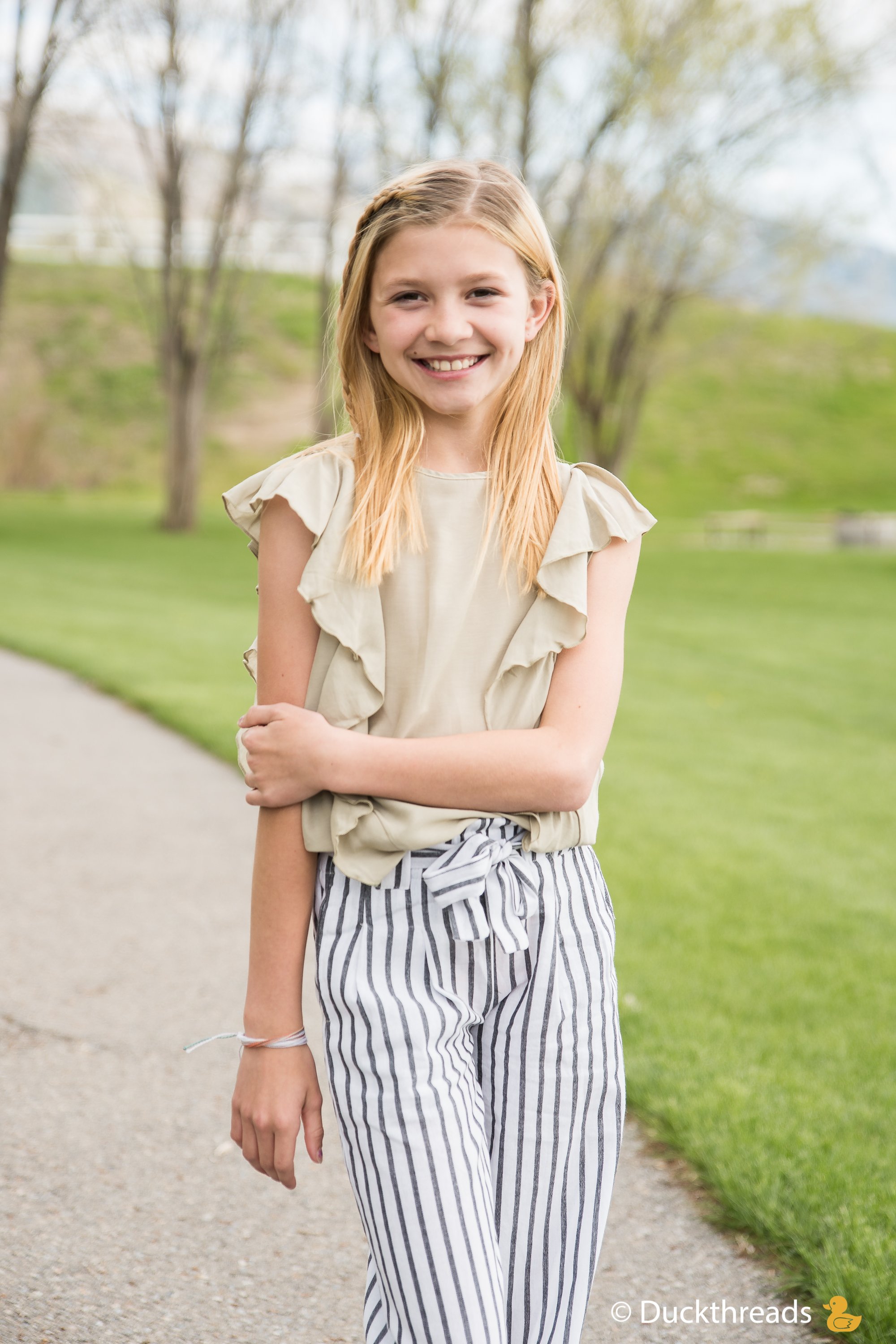 MORGAN Side Flutter Top in Sage featuring side ruffles, lightweight fabric, perfect for sunny days.