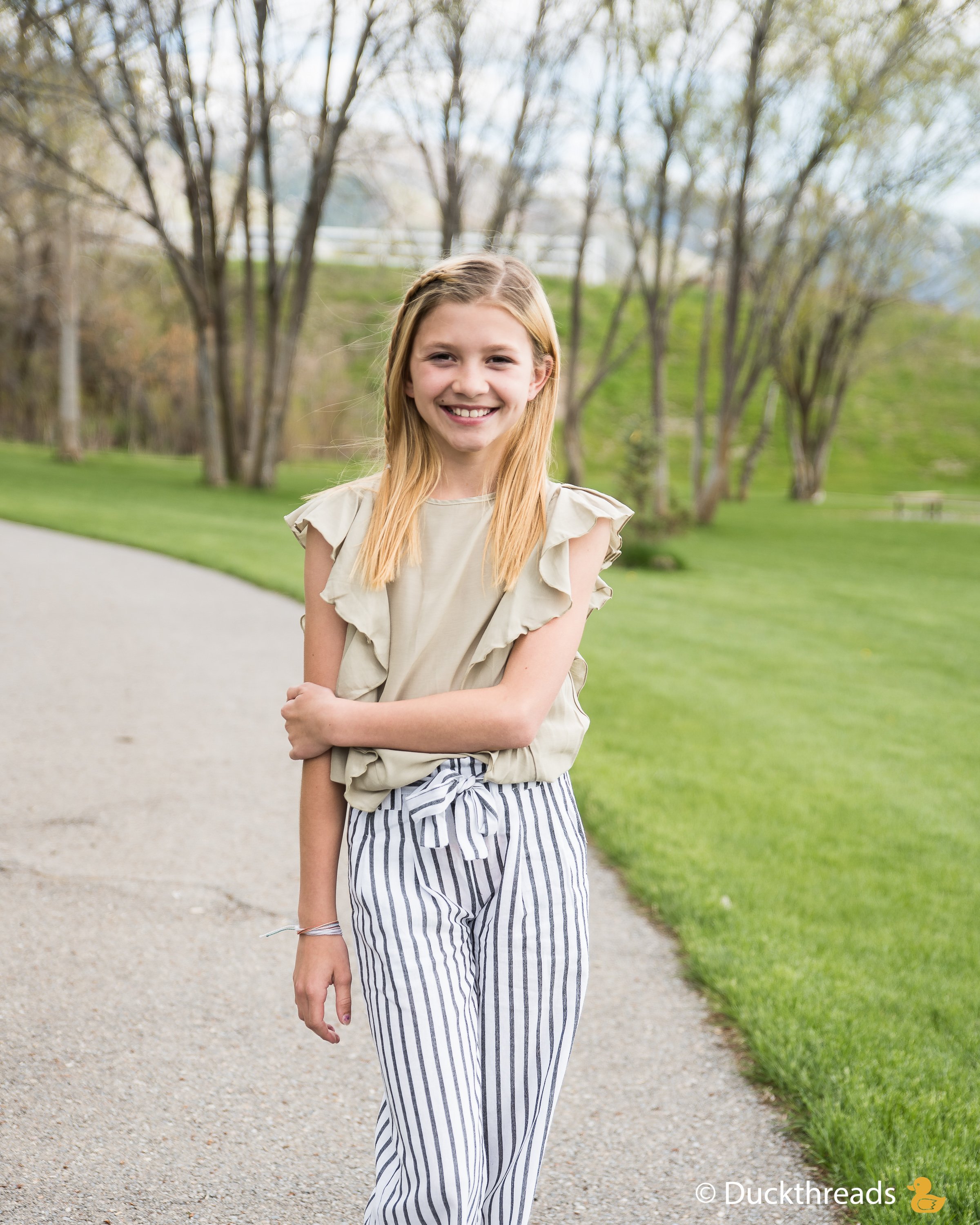 MORGAN Side Flutter Top in Sage featuring side ruffles, lightweight fabric, perfect for sunny days.