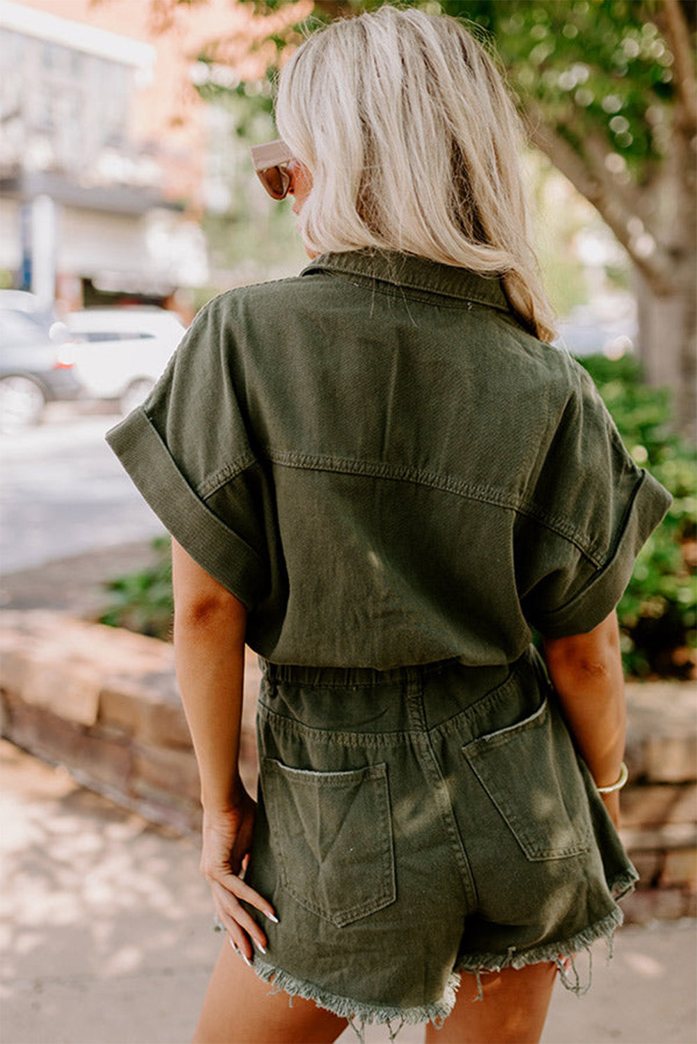 Moss Green Distressed Frayed Denim Romper featuring rolled cuffs and button closure, perfect for casual outings.