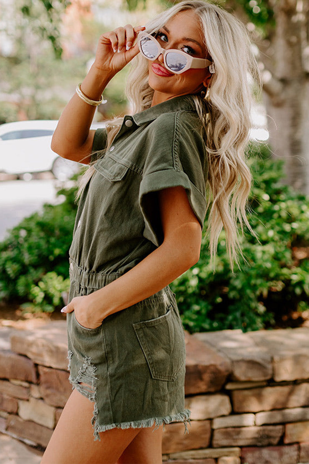 Moss Green Distressed Frayed Denim Romper featuring rolled cuffs and button closure, perfect for casual outings.