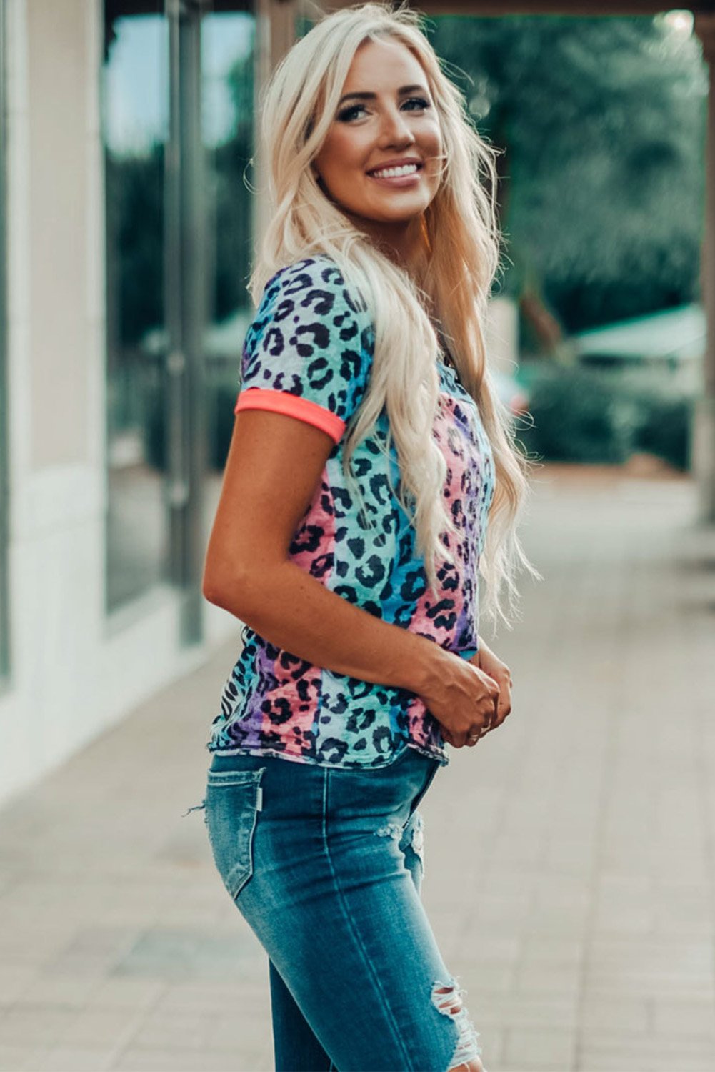 Multicolor Base Leopard T-shirt featuring an all-over leopard print design with a glowing round neckline and sleeve cuffs.