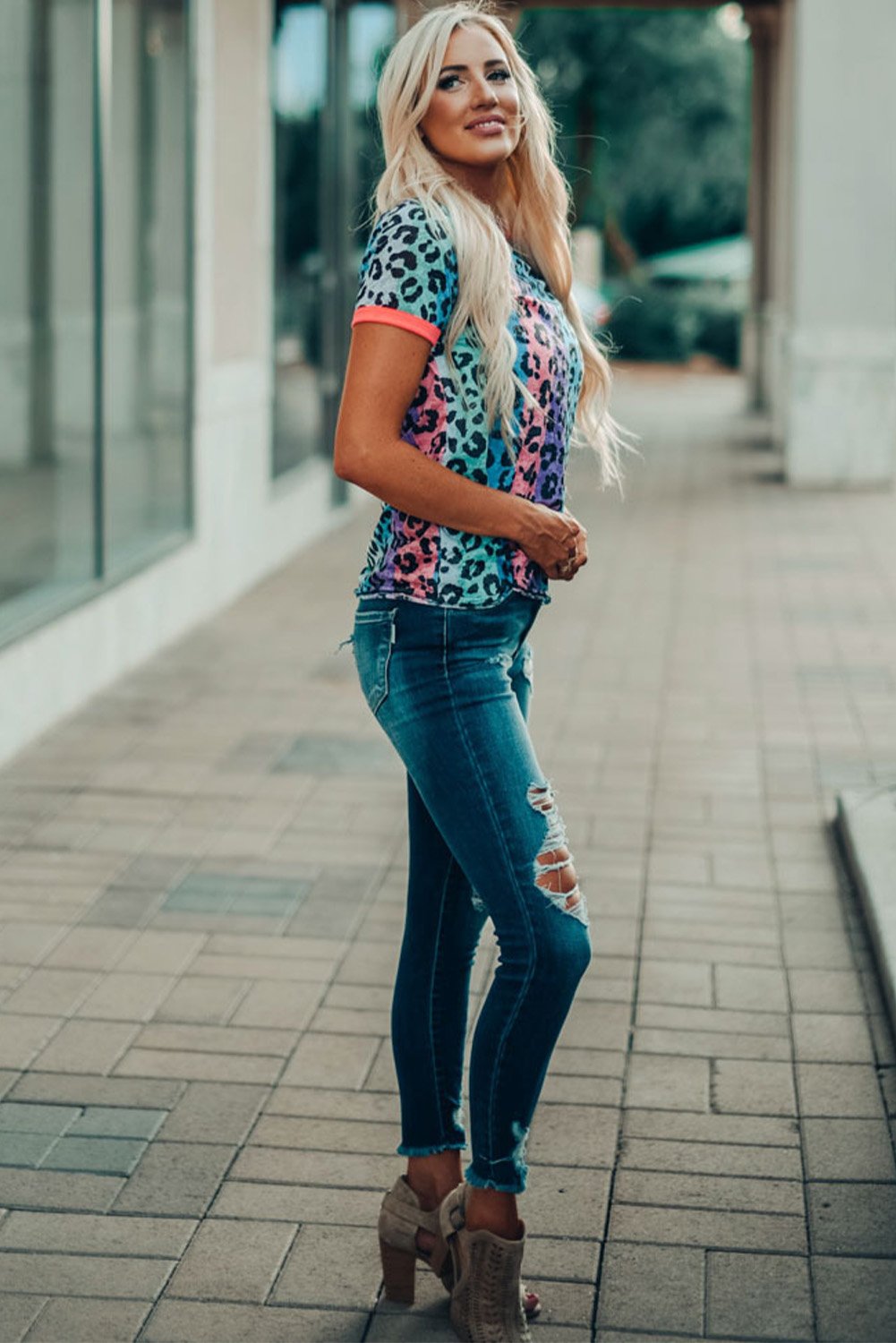 Multicolor Base Leopard T-shirt featuring an all-over leopard print design with a glowing round neckline and sleeve cuffs.