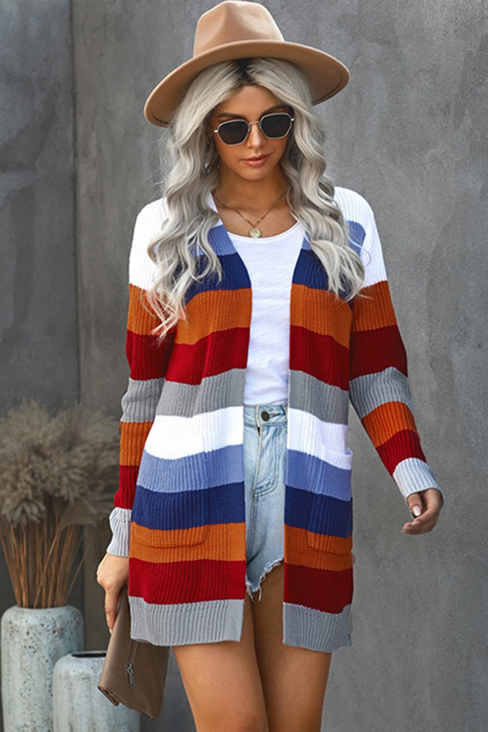 A stylish multi-color striped cardigan with pockets, perfect for casual wear, featuring a long knitted design that provides warmth and comfort.