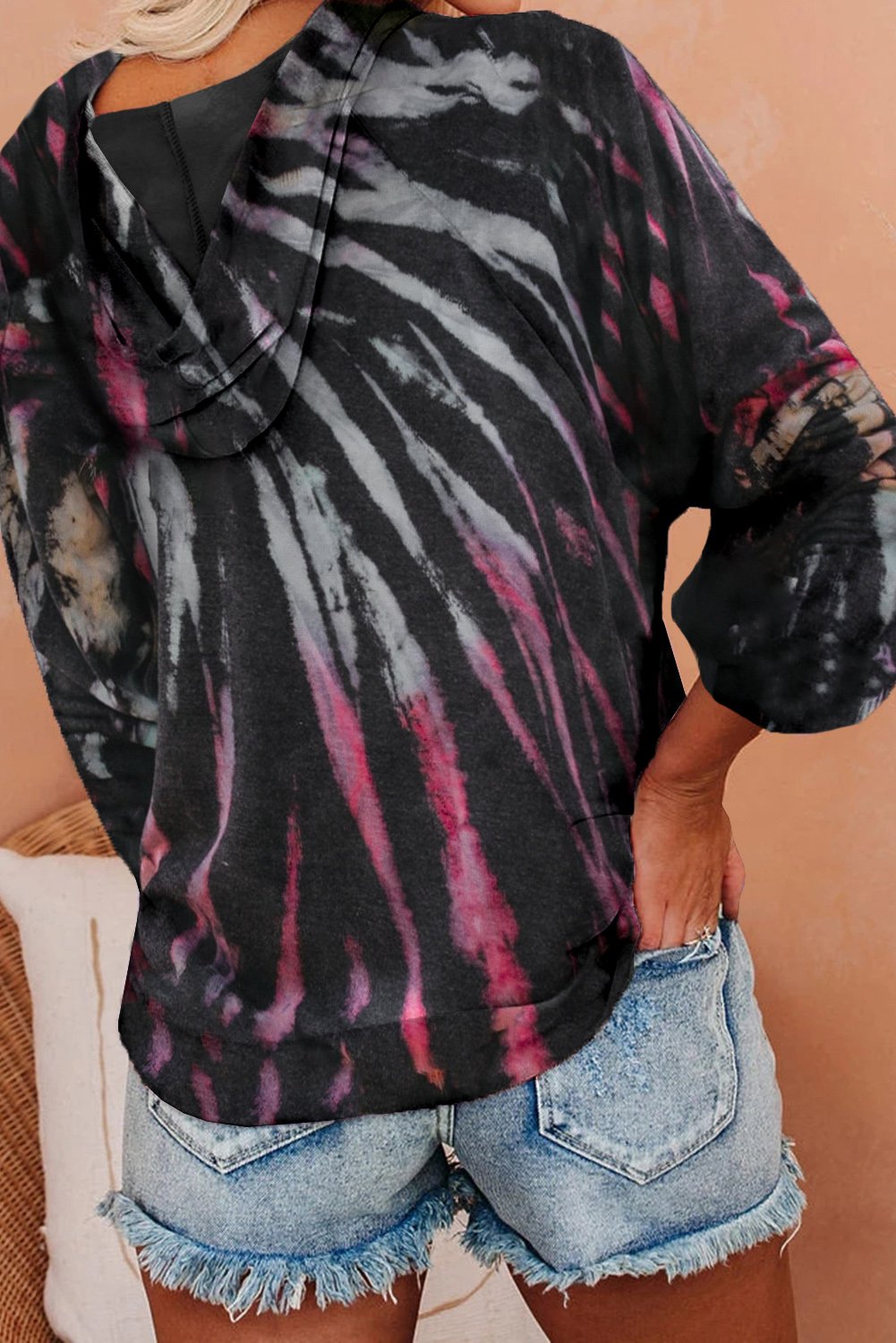 A stylish multicolor tie-dye knit hoodie displayed on a mannequin, showcasing its vibrant colors and relaxed fit.