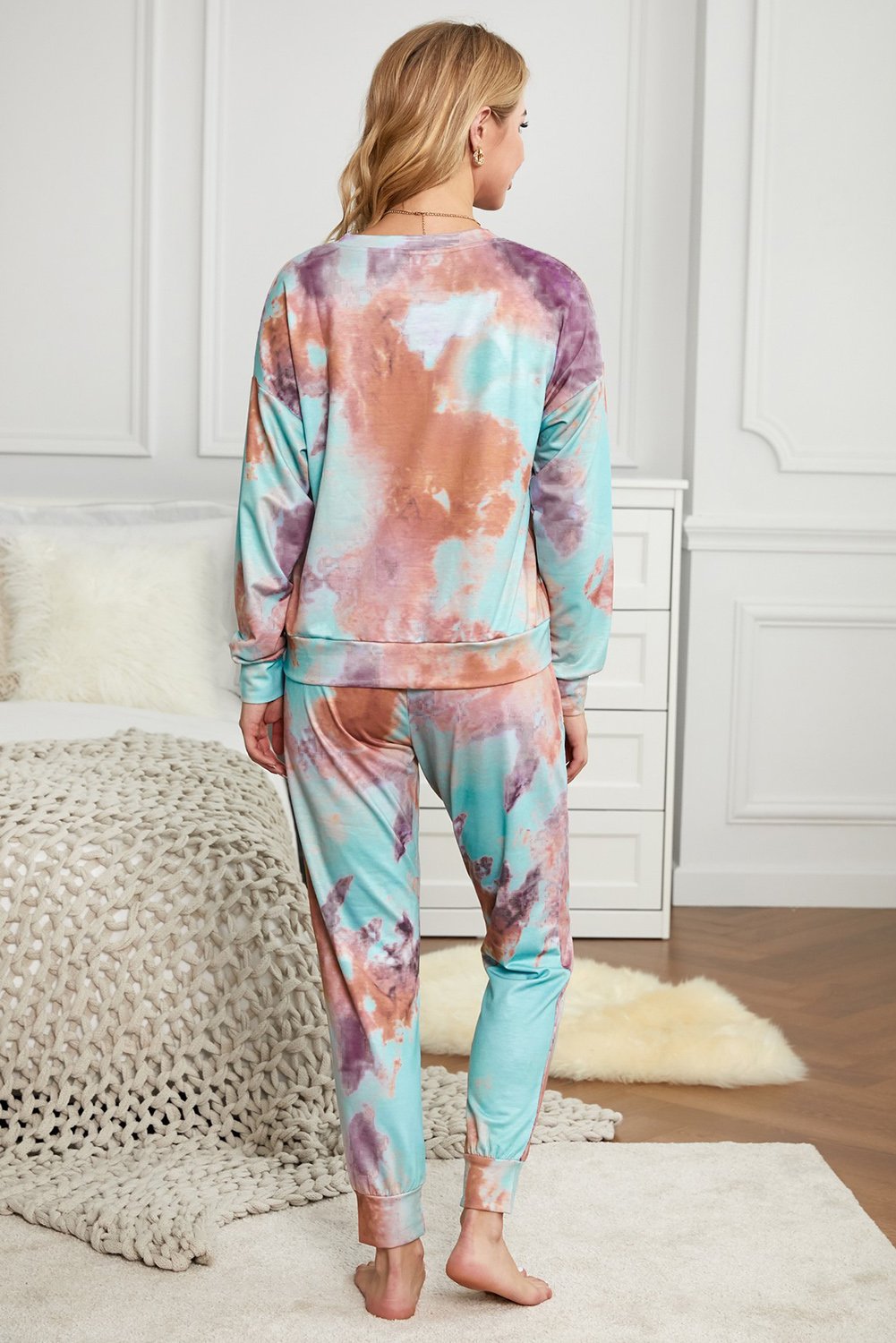 Multicolor Tie-dye Knit Lounge Set featuring a vibrant tie-dye pattern, crew neckline, long sleeves, and a chest pocket, perfect for casual lounging.