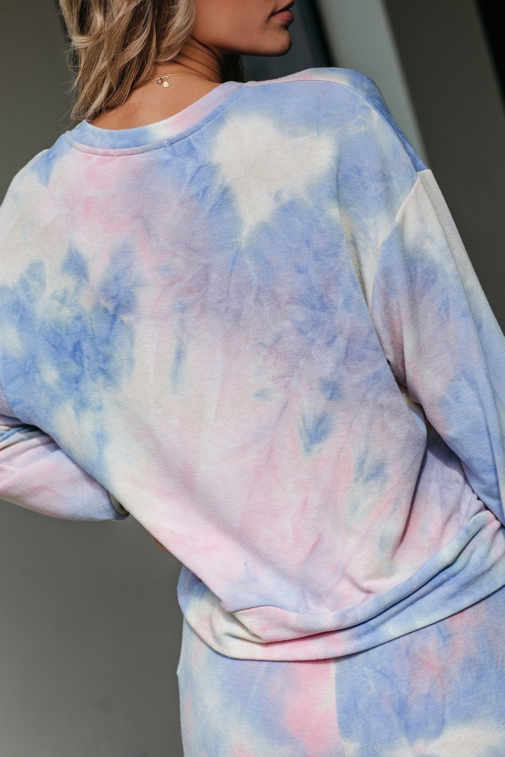 Multicolor Tie-dye Knit Lounge Set featuring a vibrant tie-dye pattern, crew neckline, long sleeves, and a chest pocket, perfect for casual lounging.