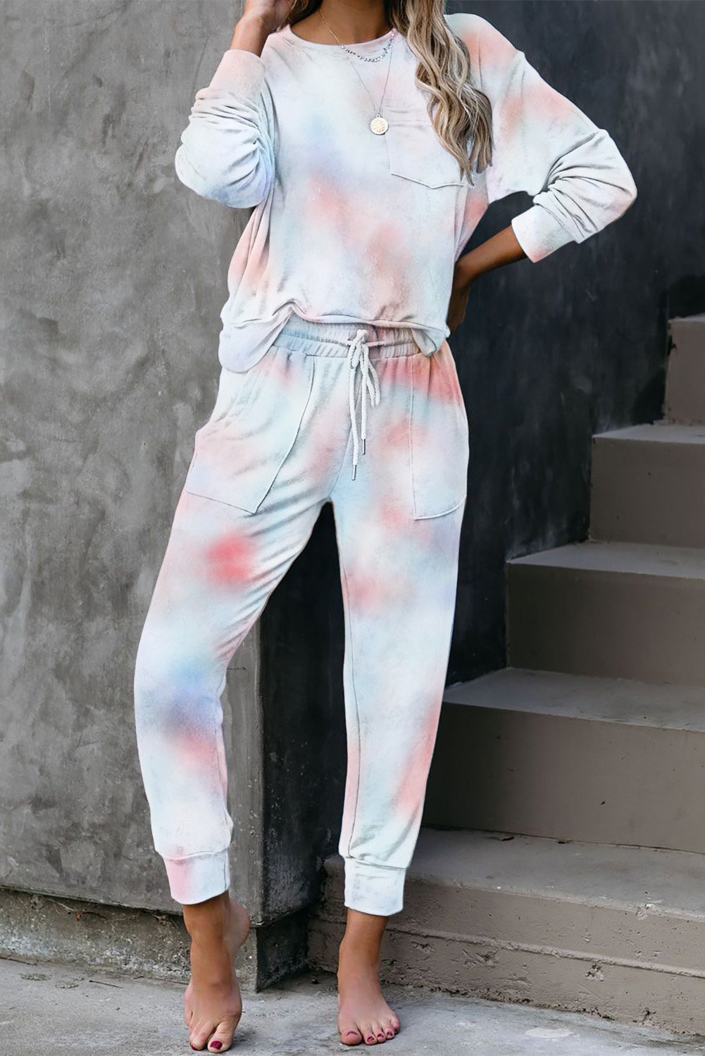 Multicolor Tie-dye Knit Lounge Set featuring a vibrant tie-dye pattern, crew neckline, long sleeves, and a chest pocket, perfect for casual lounging.