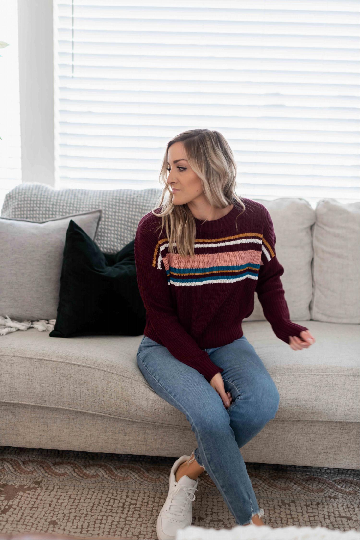 A cozy multi-striped round neck long sleeve sweater with ribbed cuffs, perfect for autumn wear.