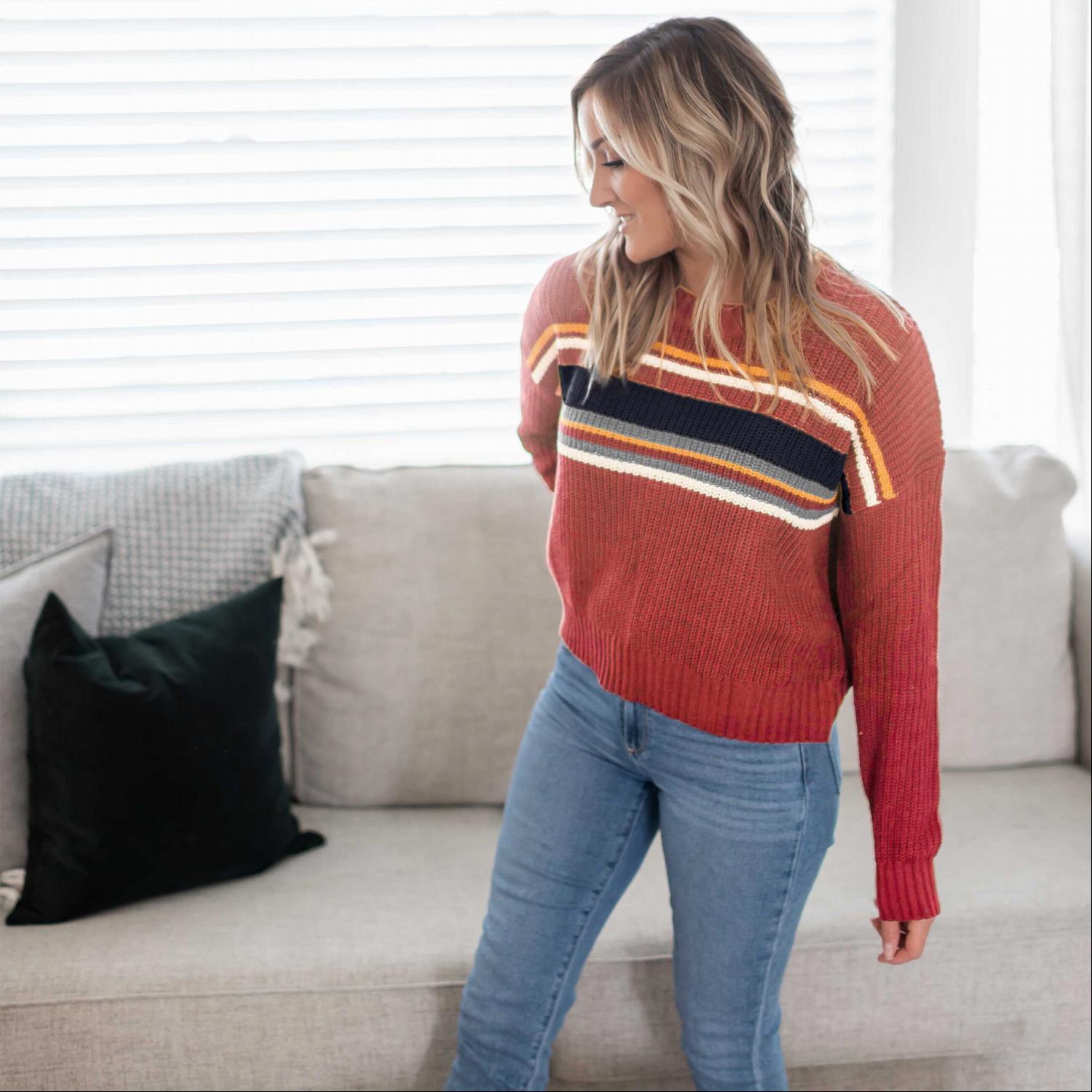 A cozy multi-striped round neck long sleeve sweater with ribbed cuffs, perfect for autumn wear.