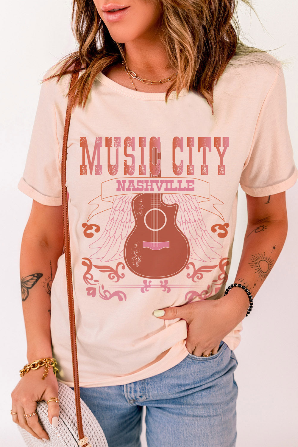 MUSIC CITY Cuffed Short Sleeve Tee featuring a chic graphic design, round neck, and short sleeves, made from a comfortable polyester-spandex blend.