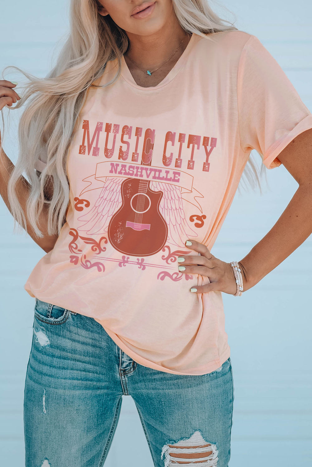 MUSIC CITY Cuffed Short Sleeve Tee featuring a chic graphic design, round neck, and short sleeves, made from a comfortable polyester-spandex blend.