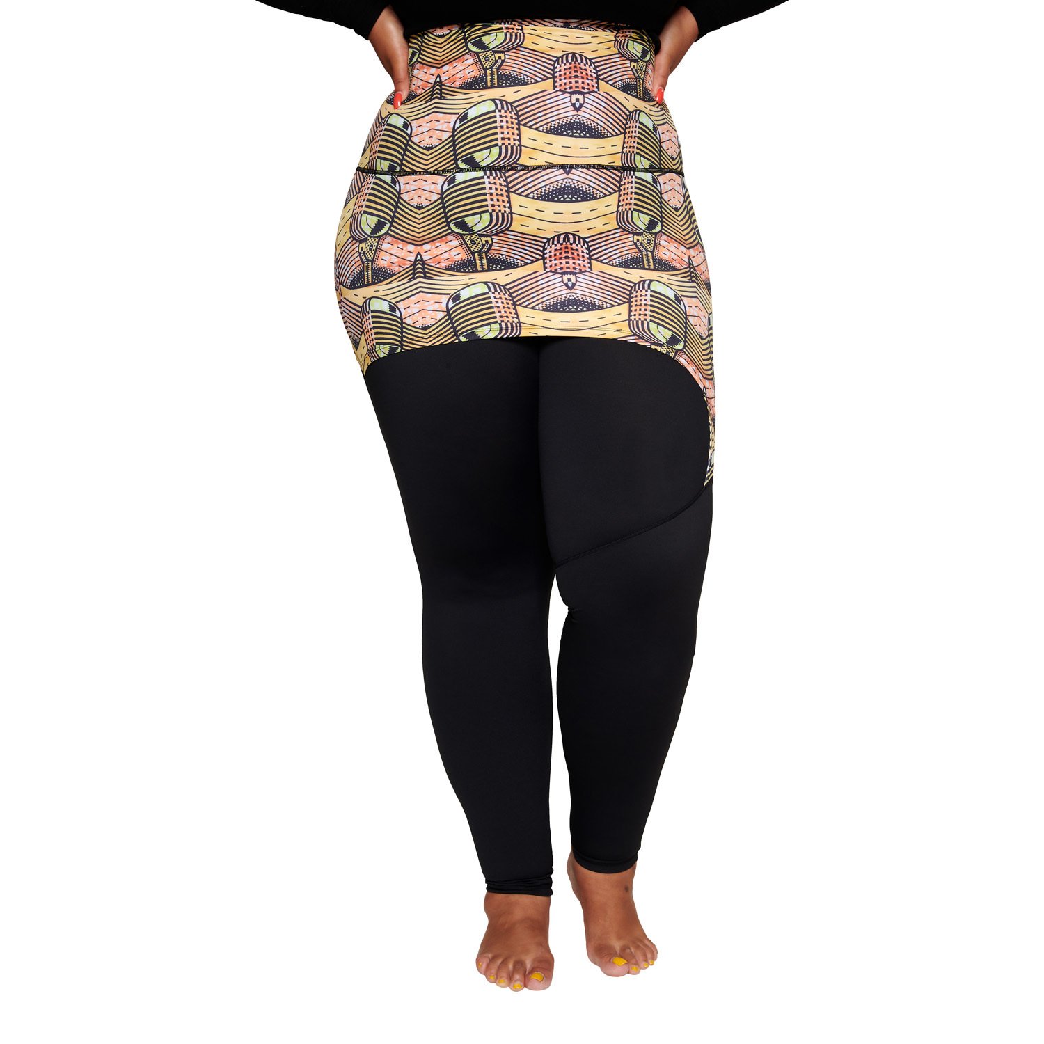 A stylish plus-sized woman wearing the Musical Skirt, showcasing its vibrant African print and comfortable fit during a workout.