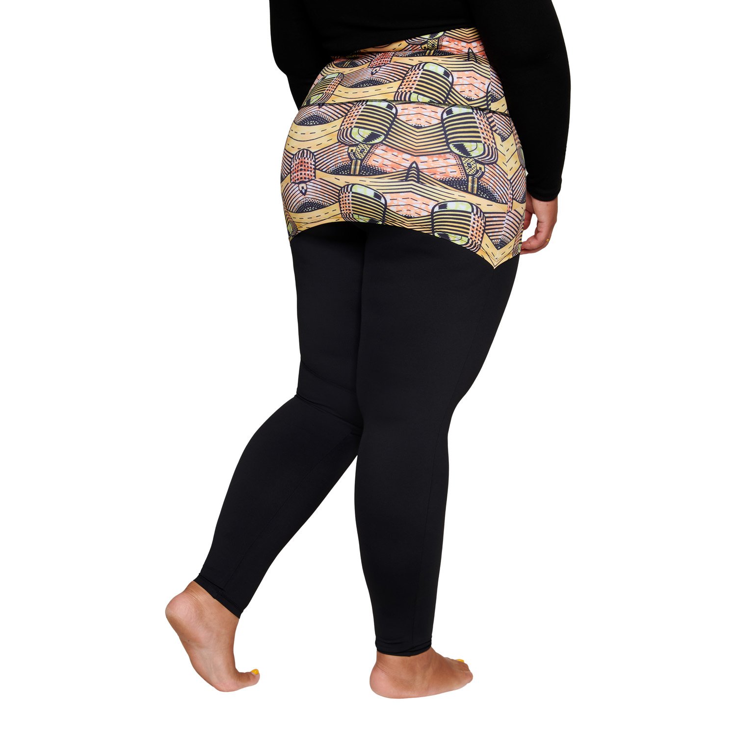 A stylish plus-sized woman wearing the Musical Skirt, showcasing its vibrant African print and comfortable fit during a workout.