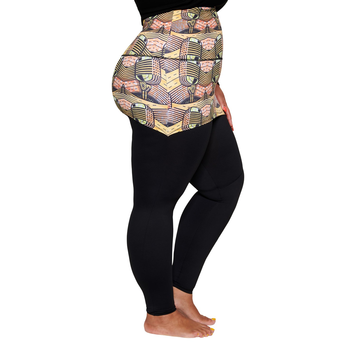 A stylish plus-sized woman wearing the Musical Skirt, showcasing its vibrant African print and comfortable fit during a workout.