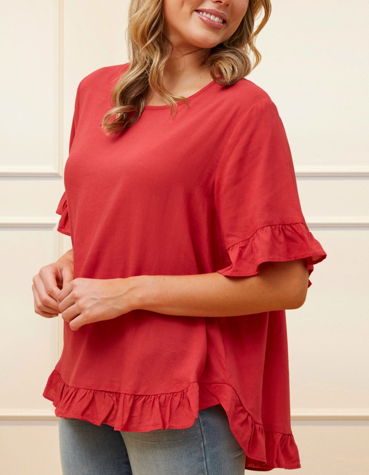 Mylene Top in a relaxed fit with frilled high-low hem, showcasing its breathable linen blend fabric and stylish design in vibrant colors.