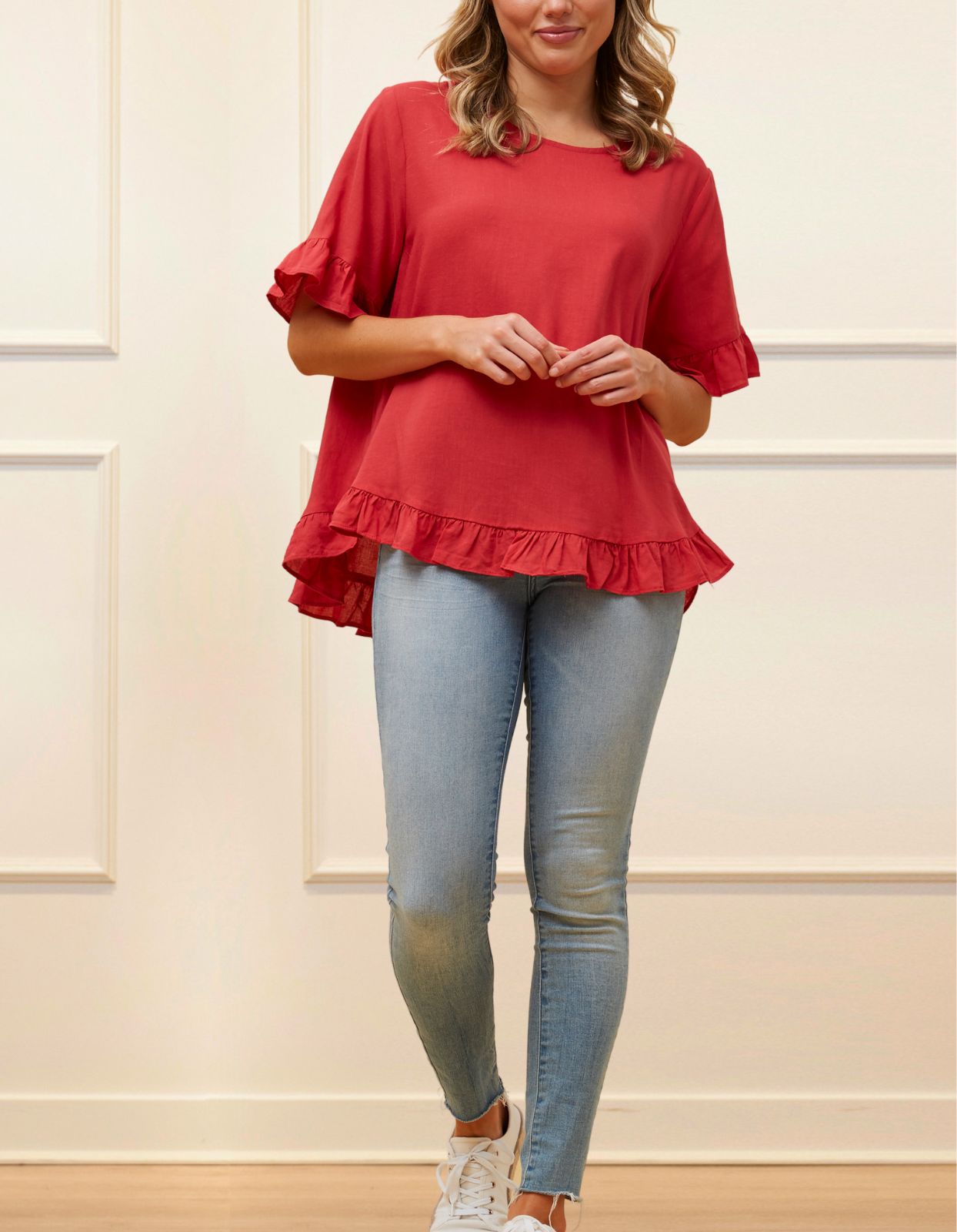 Mylene Top in a relaxed fit with frilled high-low hem, showcasing its breathable linen blend fabric and stylish design in vibrant colors.