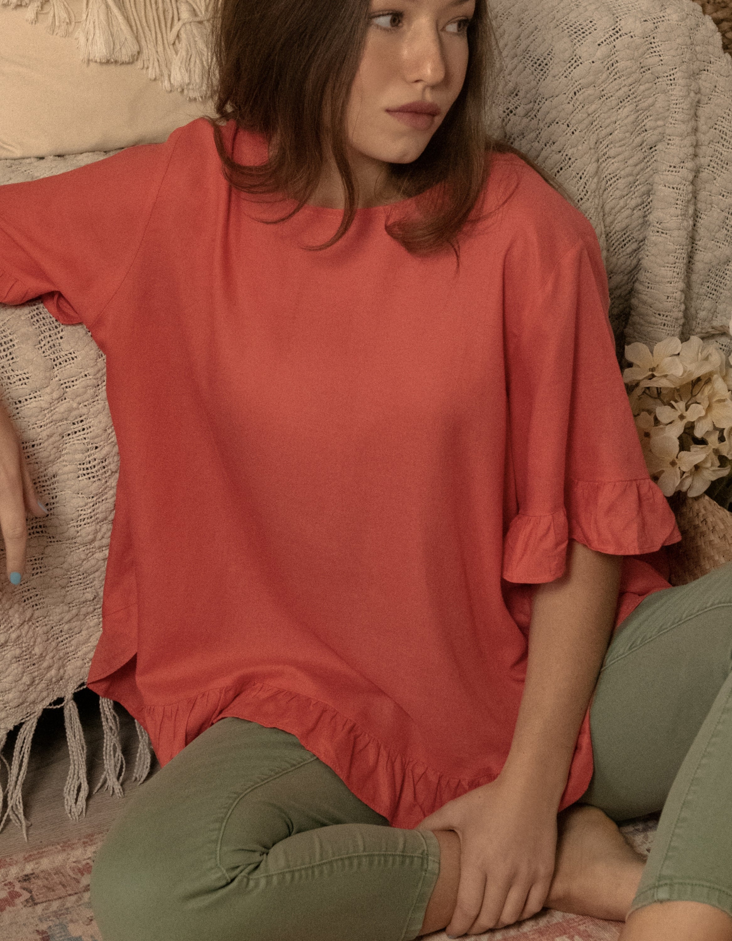 Mylene Top in a relaxed fit with frilled high-low hem, showcasing its breathable linen blend fabric and stylish design in vibrant colors.