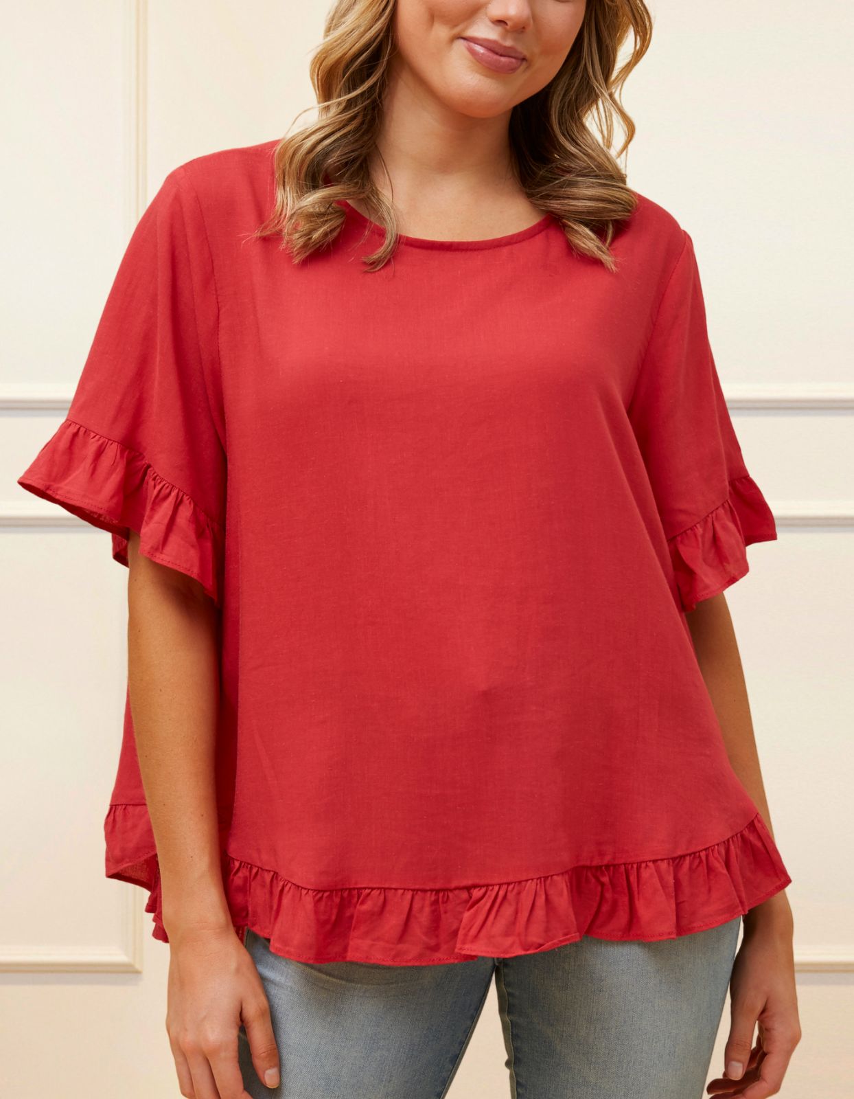 Mylene Top in a relaxed fit with frilled high-low hem, showcasing its breathable linen blend fabric and stylish design in vibrant colors.