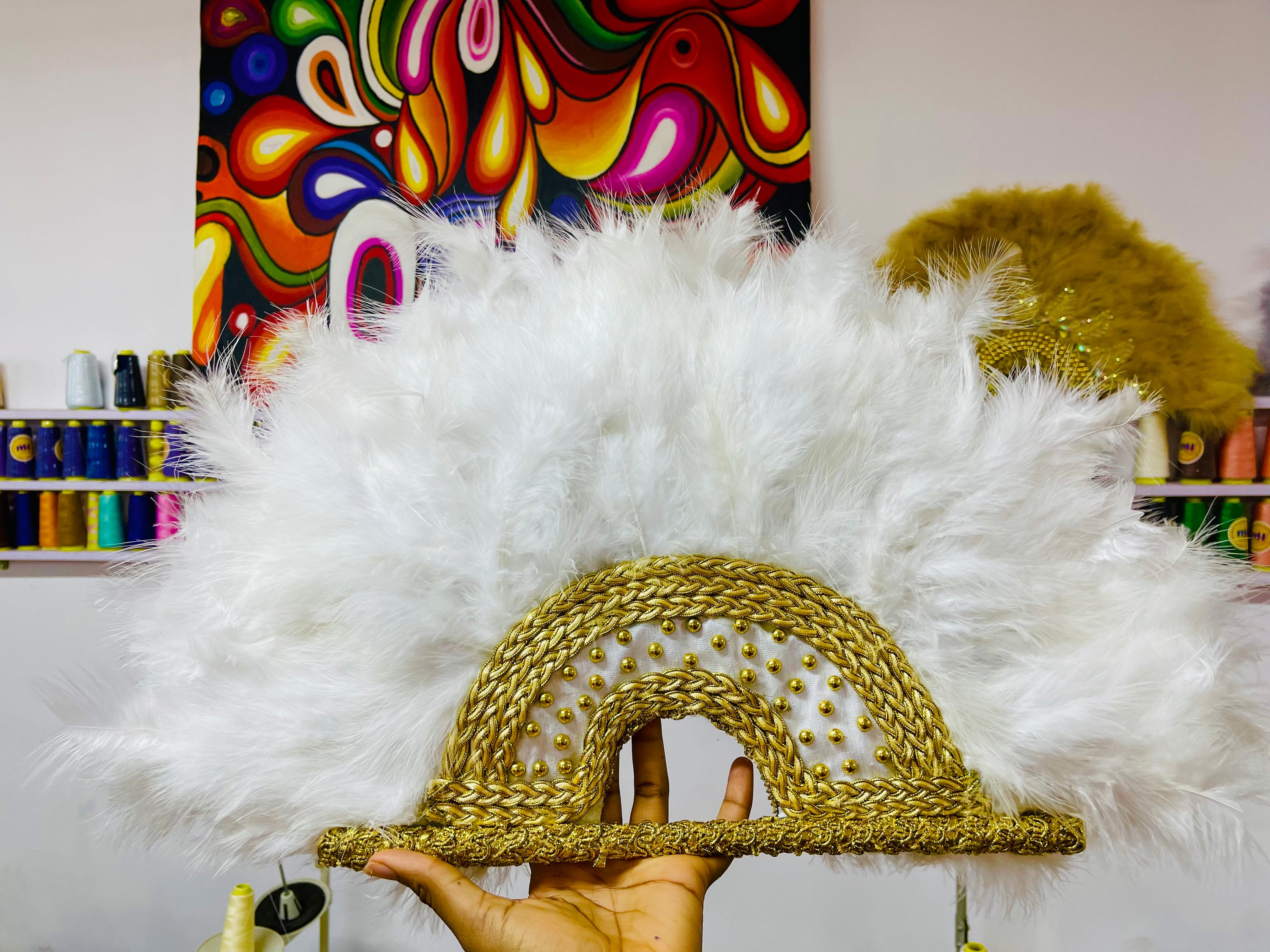 Nadia Dance Fan featuring fluffy feathers, customizable colors, and elegant tassels, perfect for dance performances.